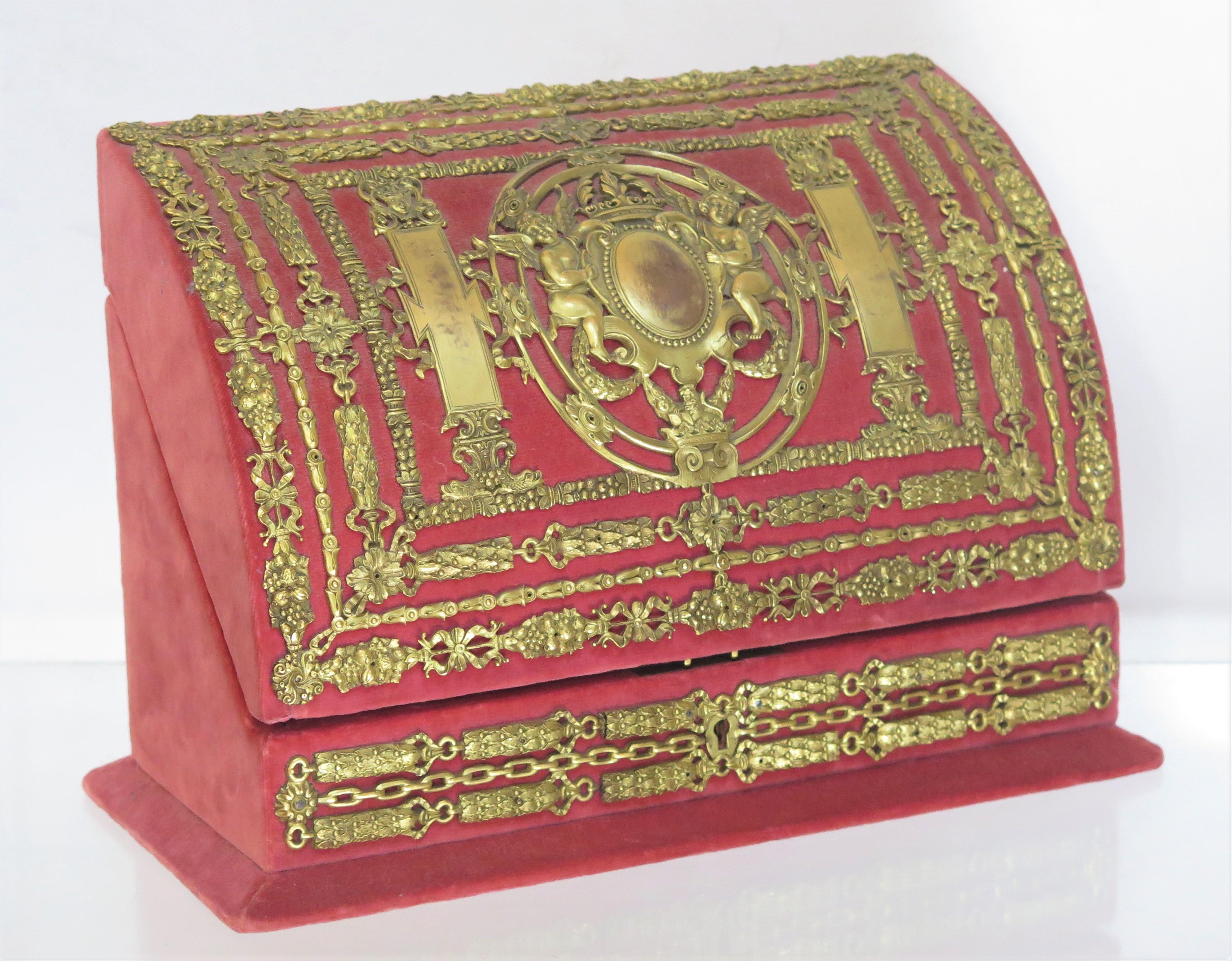 gilt bronze mounted rose velvet letter box with putti flanking an elaborate central shield / cartouche in the style of Edward F. Caldwell & Co, New York. New York, the interior is fitted with various compartments, English, 20th century

some visible