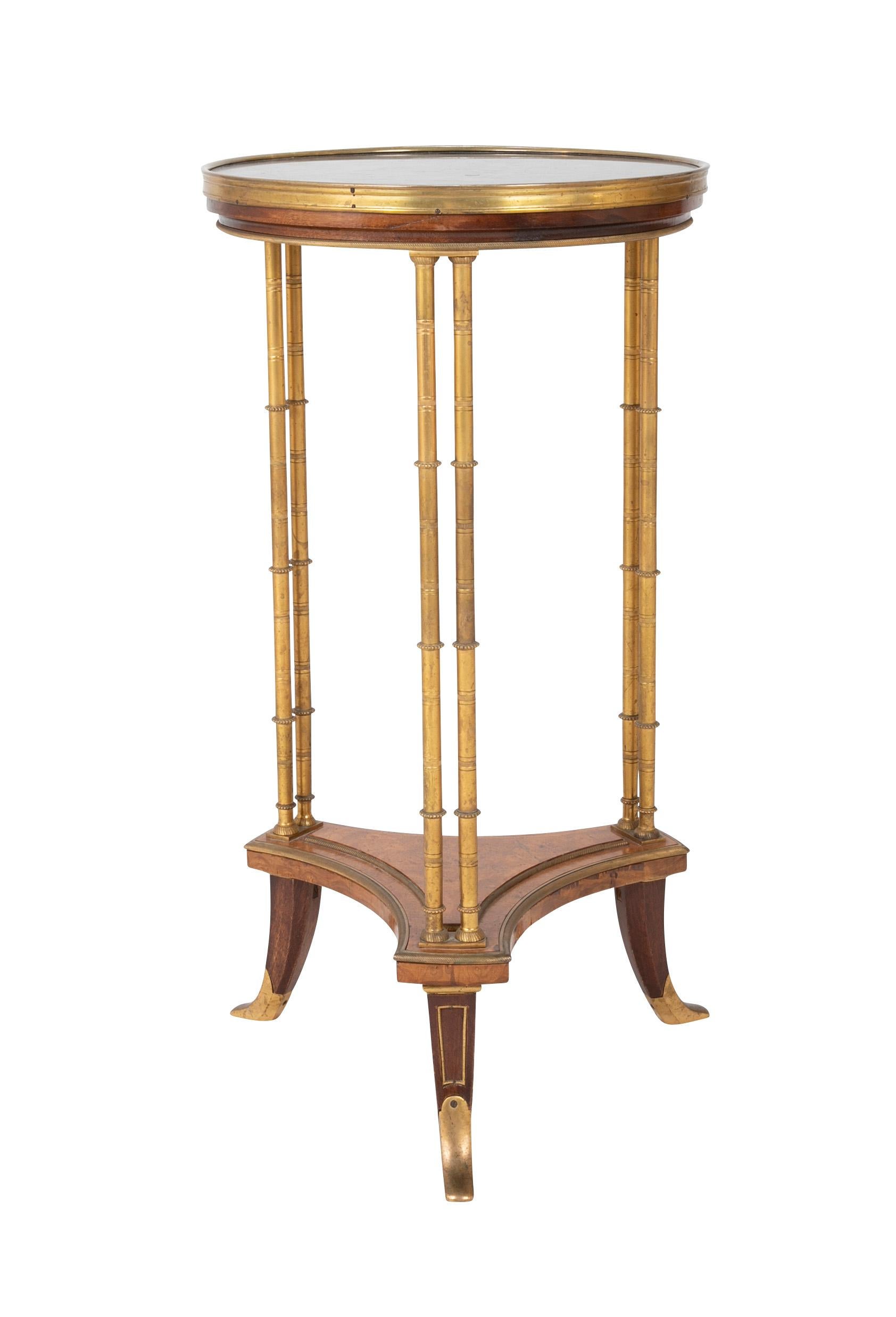 French Louis XVI gilt-bronze mounted Amboyna burr and mahogany Louis XVI style guéridon after the model by Weisweiler (1750-1810) with black marble top.   Circa 1880