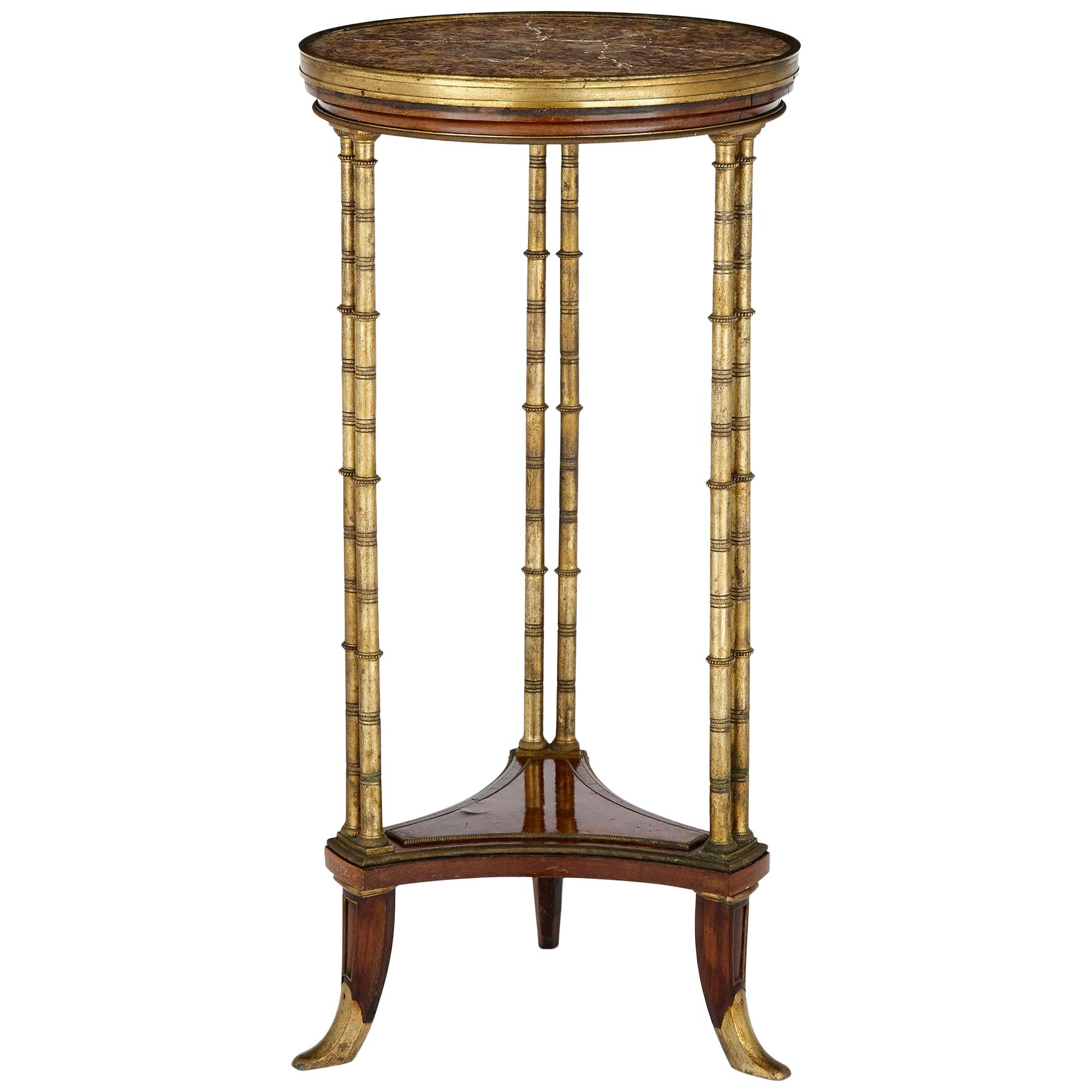 Table ronde en acajou montée sur bronze doré par Henry Dasson en vente