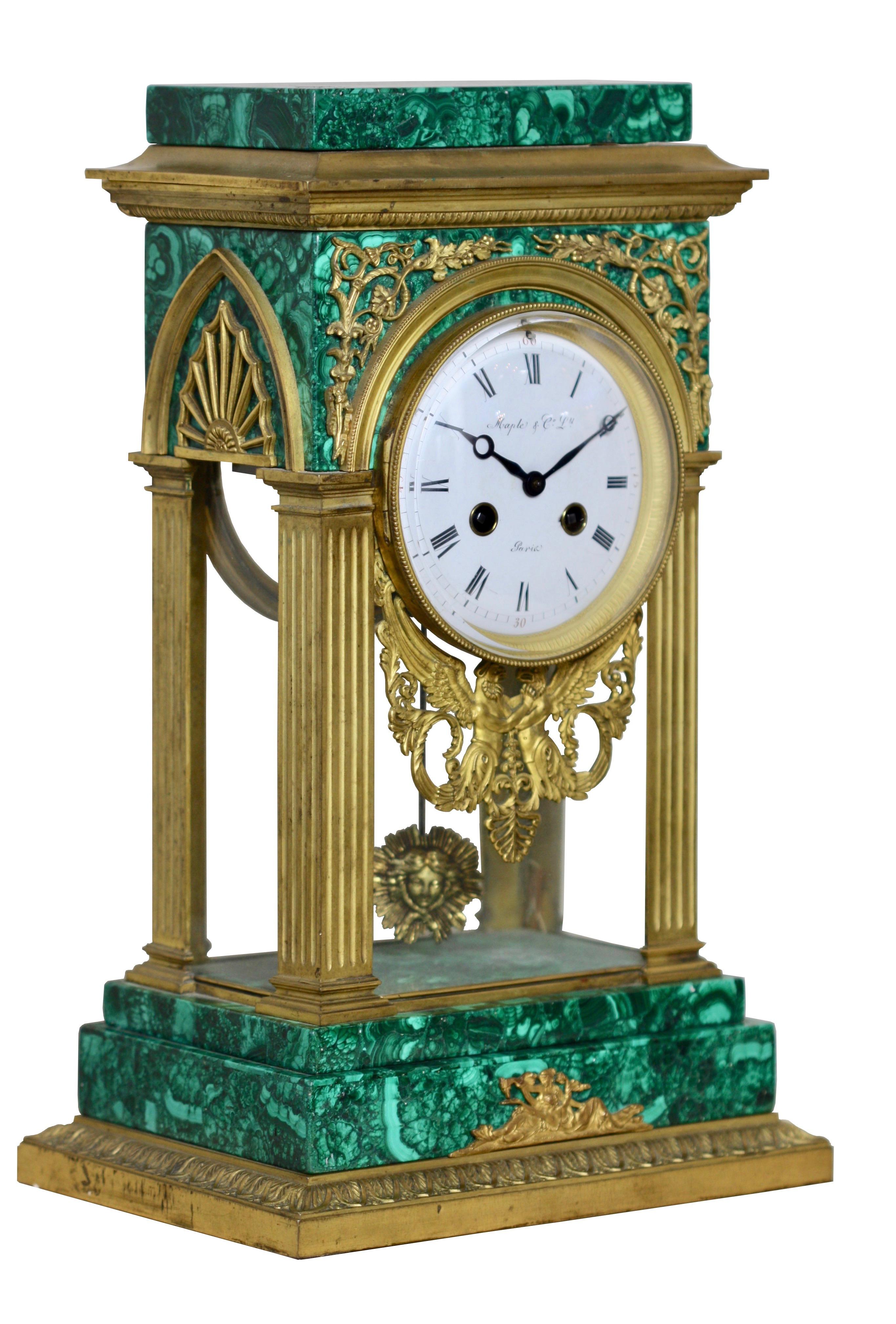 Gilt bronze mounted malachite mantel clock, Louis XVI style
Maple & Co.,
France, 19th century

The circular white enamel dial with black Arabic numerals, glazed front, sides and rear door, the base of the dial decorated by a cast mount in the