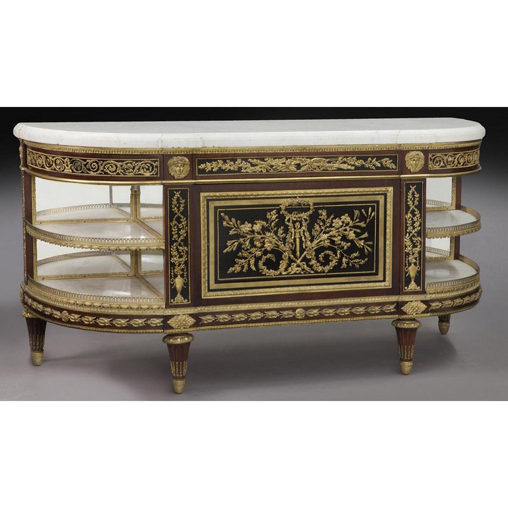 This admirable fine console has a shaped marble top; inset within gilt-bronze border; on a conforming base with decorated gilt bronze mounts. Below is a central cupboard with finely cast gilt-bronze mounts of ribbon tied garlands. The cupboard is