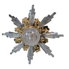 Pendentif en bronze doré avec rayons en cristal, signé Baccarat