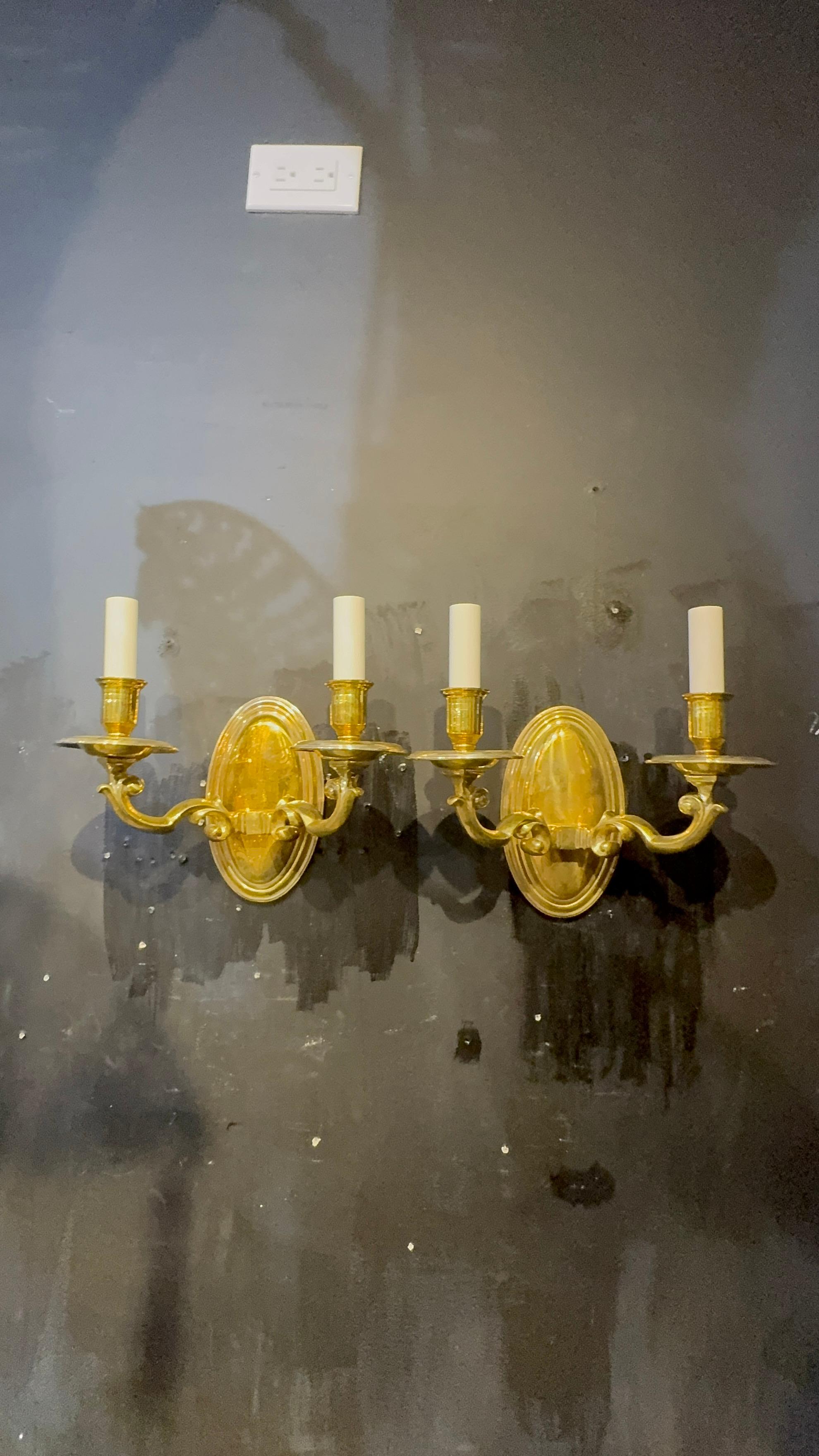 A pair of circa 1920’s gilt bronze colonial style sconces