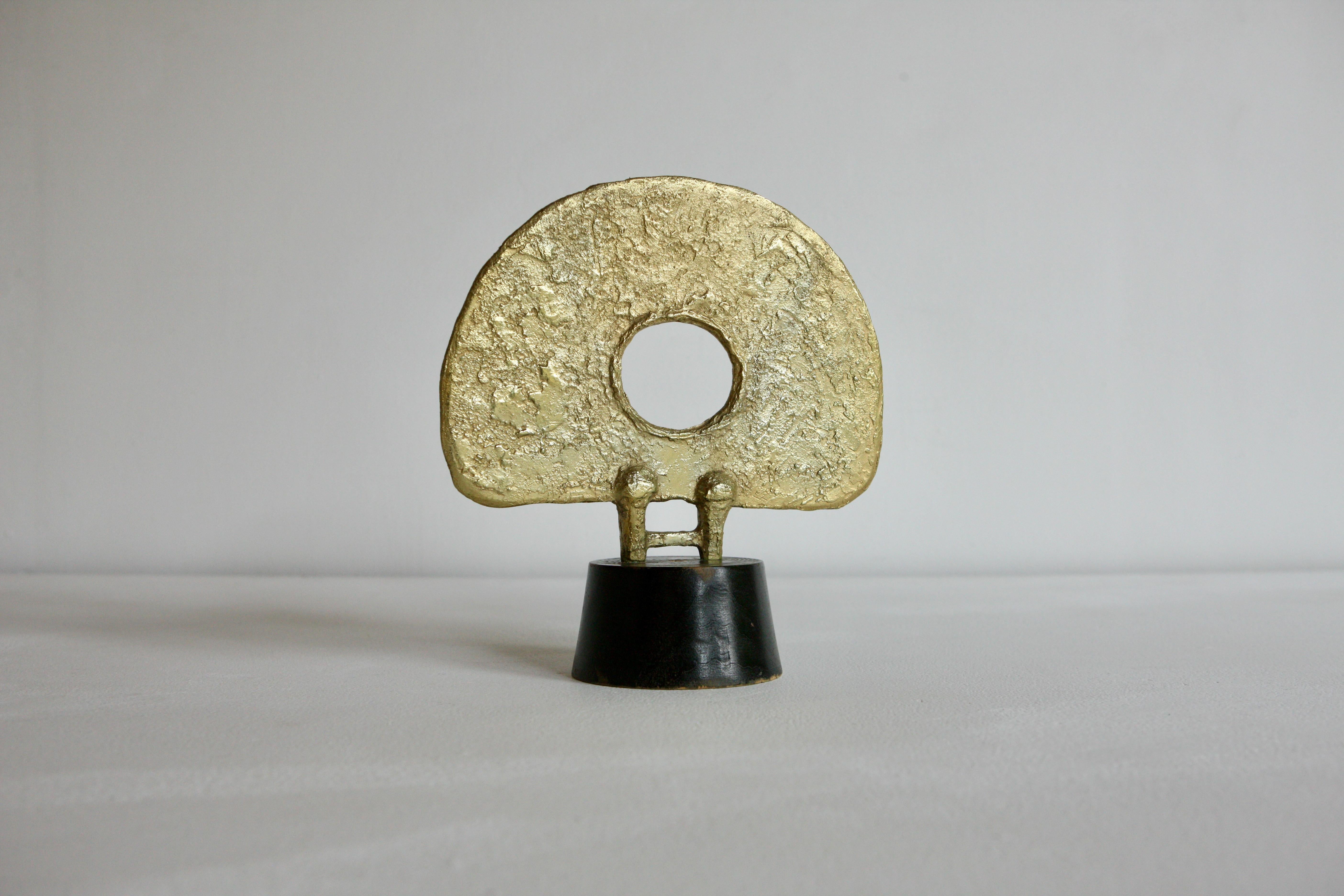 A modernist sculpture reminiscent of Hepworth. The piece is in Gilt Bronze and mounted on a turned plinth.