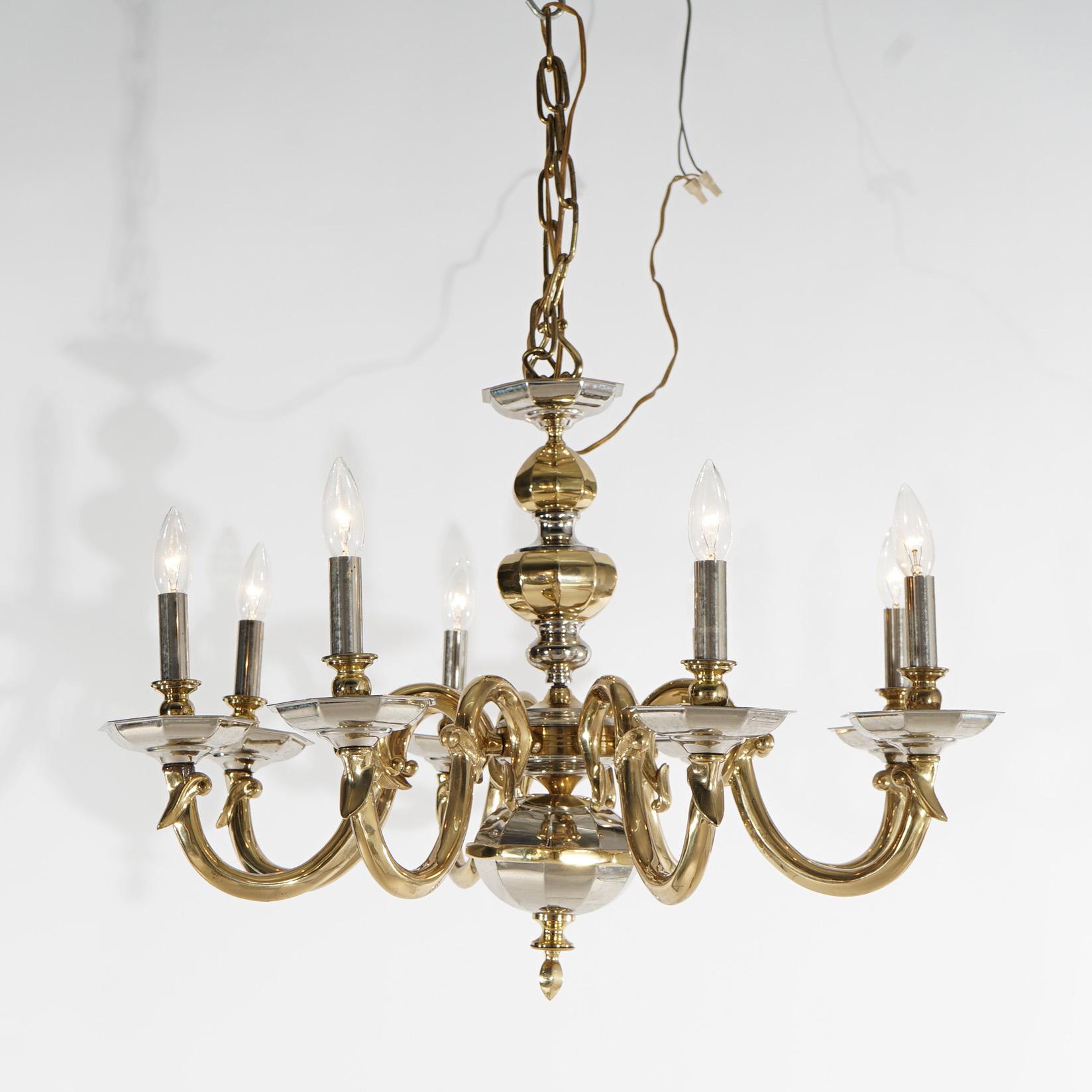 A gilt bronze chandelier offers faceted central font with eight scrolled foliate form arms terminating in candle lights, 20th century

Measures- 21.5''H x 29.5''W x 29.5''D; 20.5'' drop