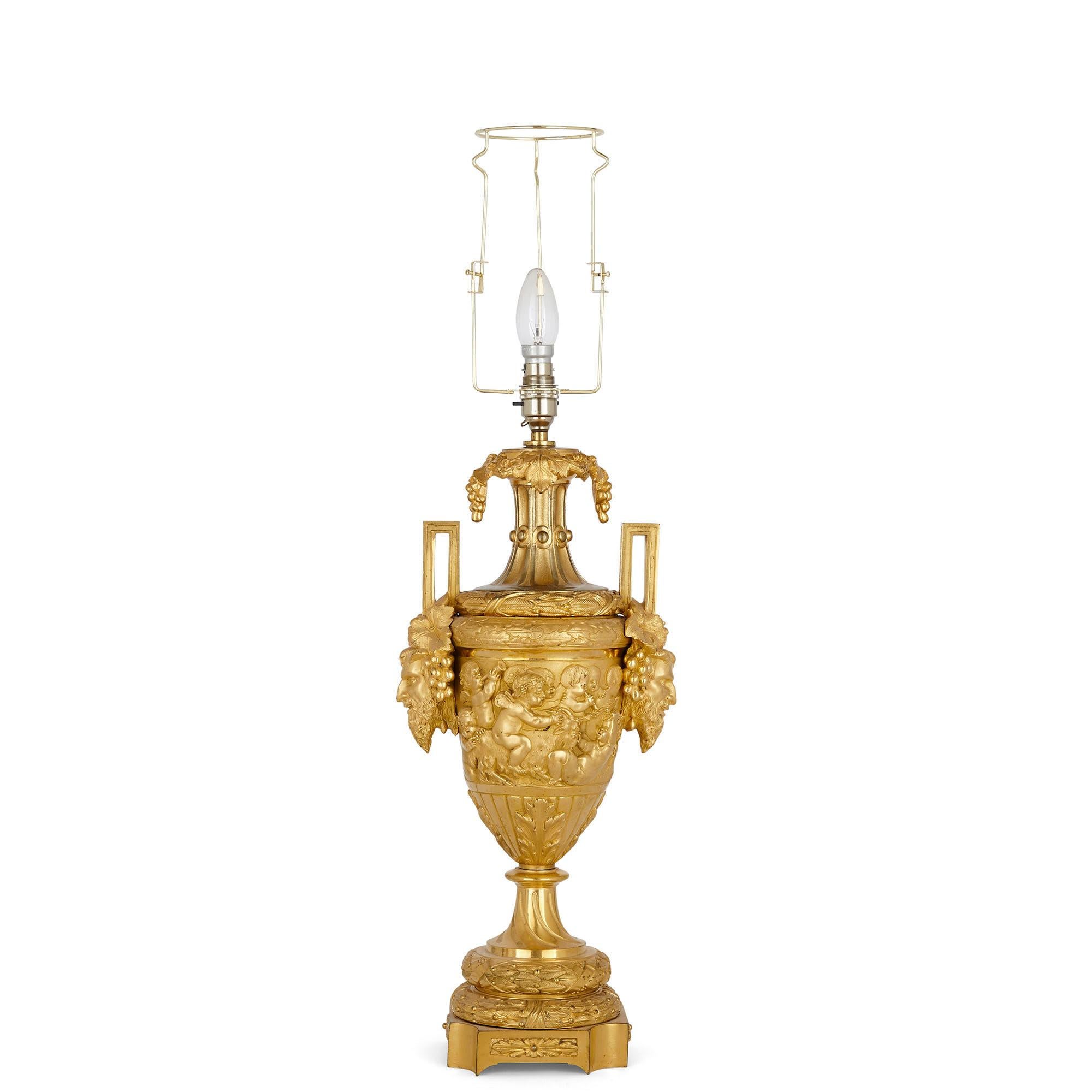 Gilt bronze table lamp in the Rococo style
French, late 19th century
With shade: Height 65cm, diameter 55cm
Without shade: Height 49cm, width 25cm, depth 17cm

This wonderful Rococo style lamp, crafted from gilt bronze, is designed in the