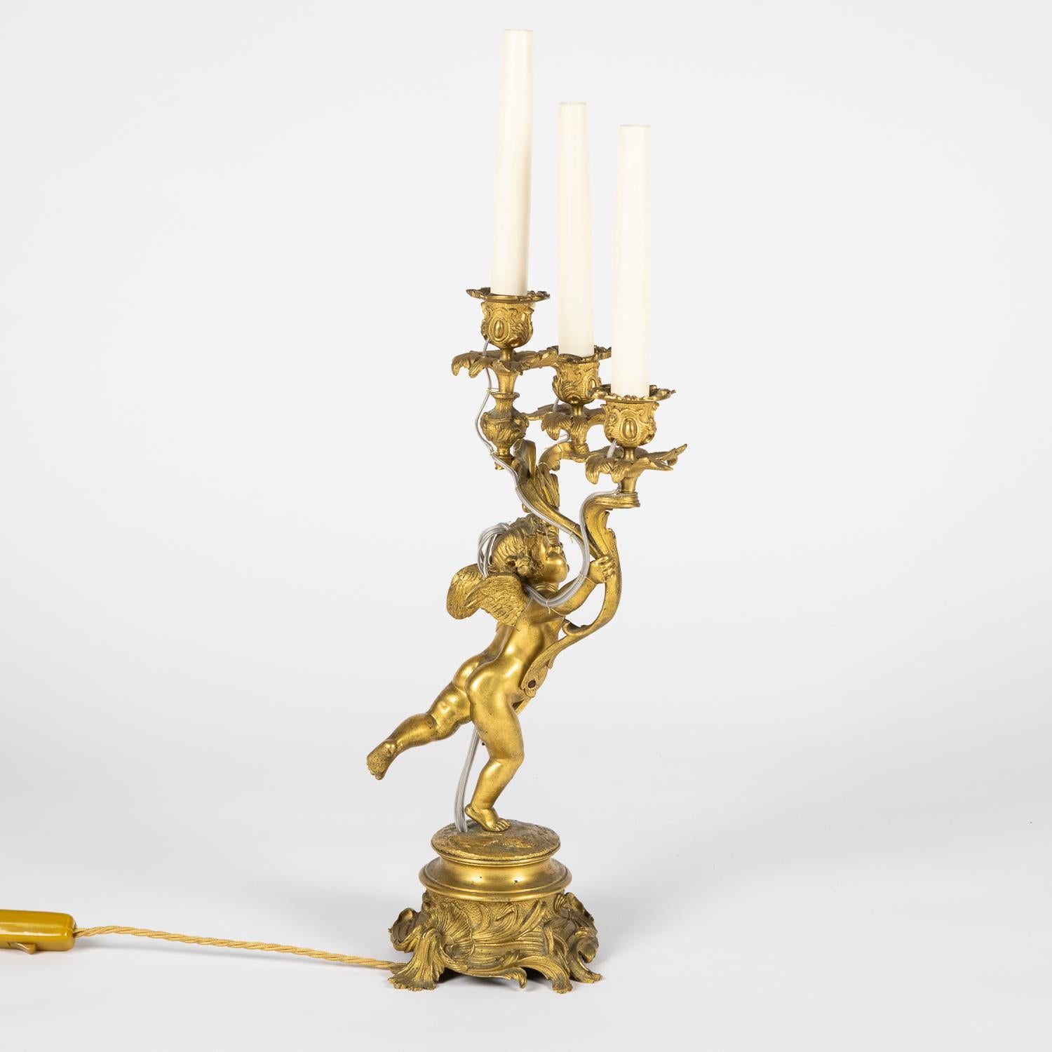 A pair of French late 19th century gilt bronze three arm candlesticks, converted to electricity.

Re-wired and tested.