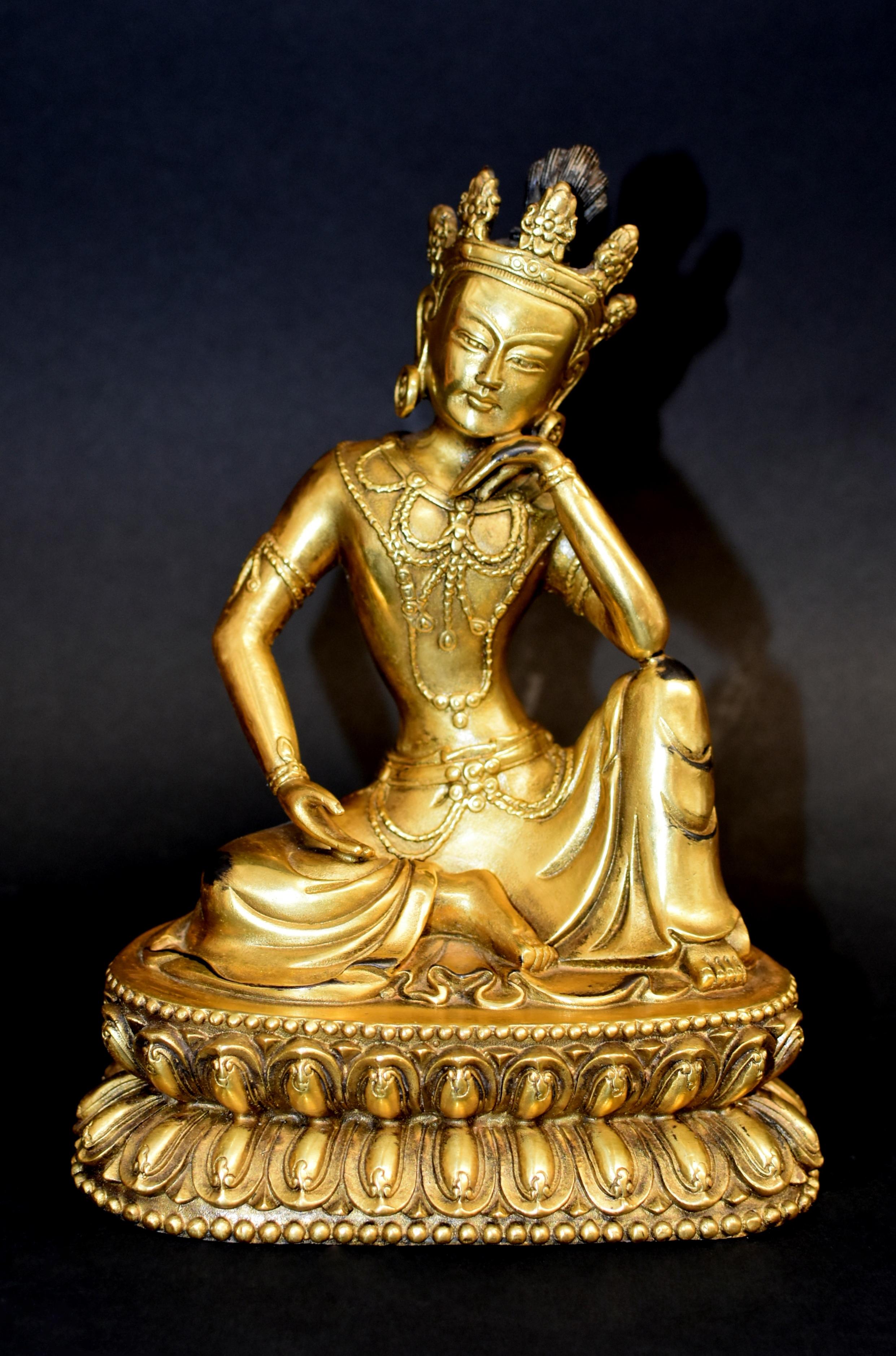 A magnificent gilt bronze statue of Tibetan Avalokiteshvara, the compassionate Bodhisattva Water Moon Guan Yin. Seated on a lotus base in rajalilasana, the 