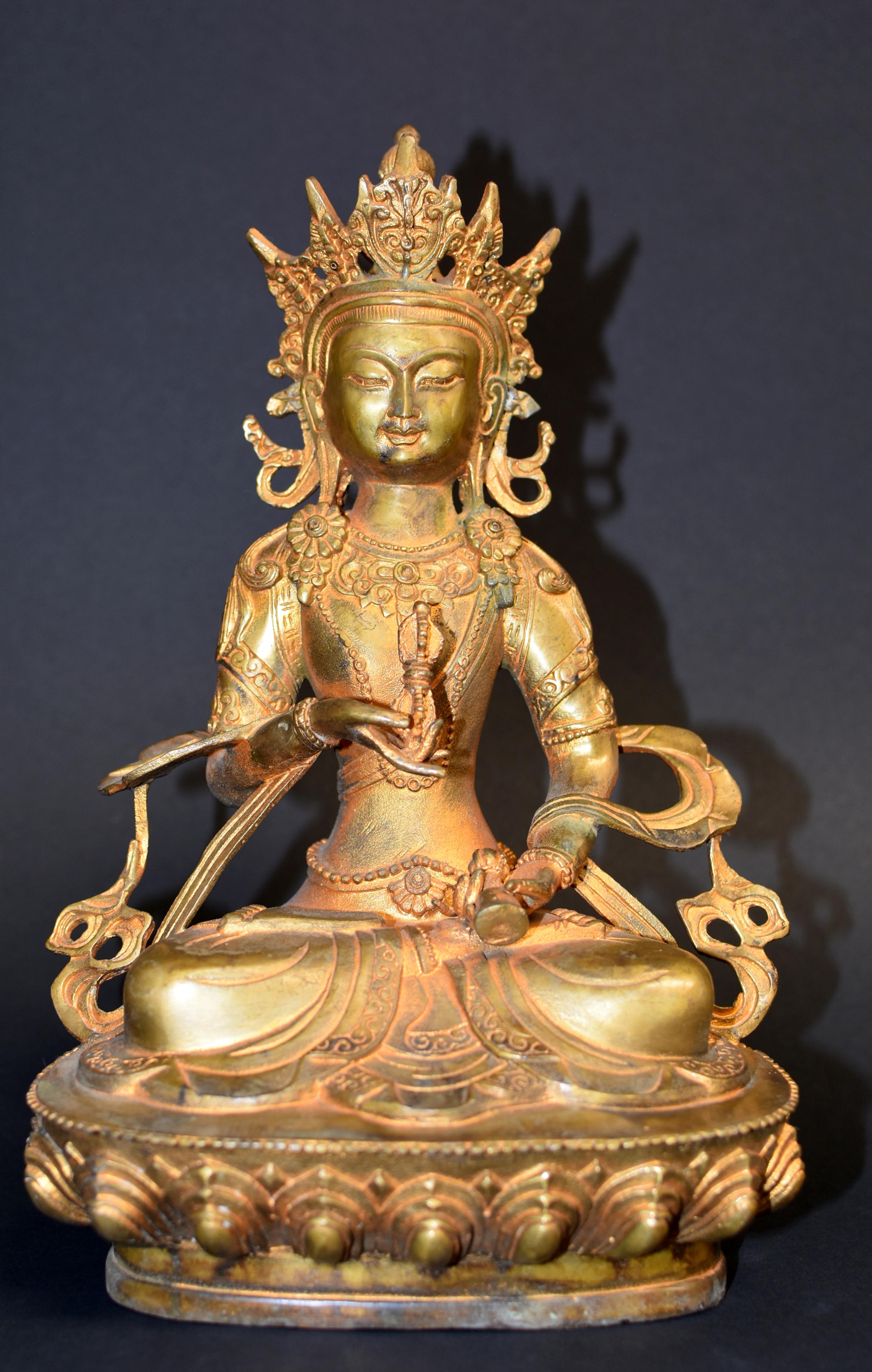 A beautiful 20th century statue of Tibetan Bodhisattva Vajrassatva. The Vajrassatva is a deity who removes bad karma, compels one's compassion and inspires strong devotion to prevent harm to others. Sitting pasmadana on a lotus throne, Buddha's