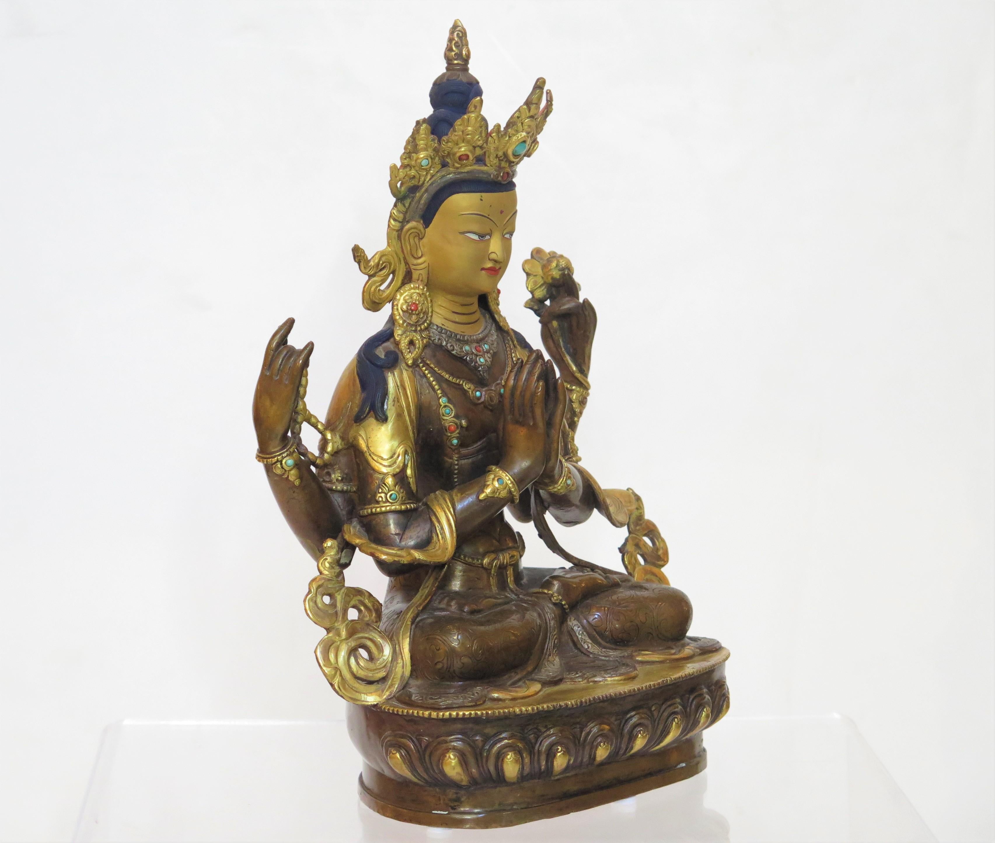 mid-20th century Tibetan Buddhist Deity Chenrezig (Four-Armed Avalokiteshvara), gilt metal / brass with blue hair, red inside of crown.

Chenrezig Bodhisattva, also known as Avalokitesvara, 