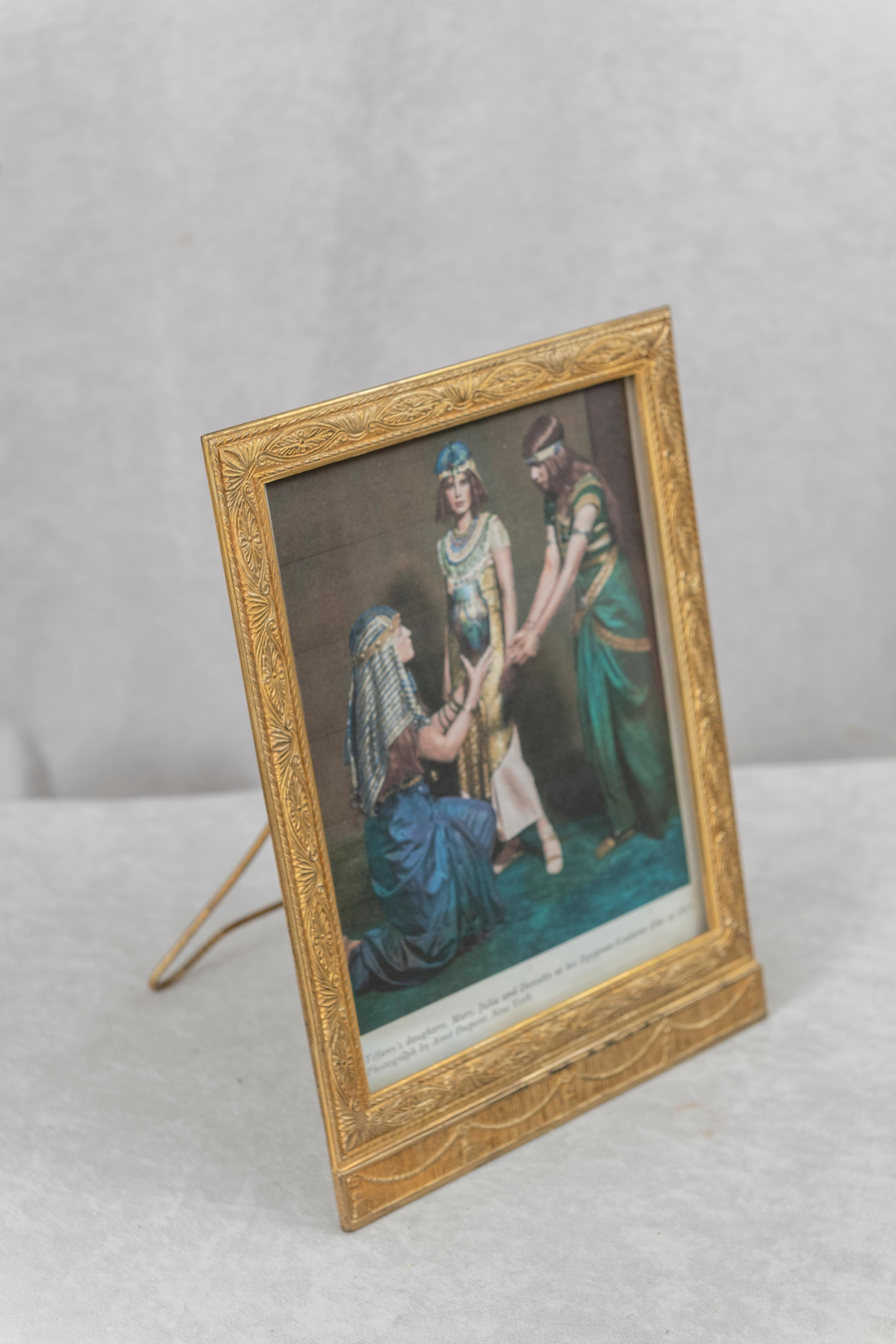   This rich and beautiful gilt bronze Tiffany Studios frame done in a neoclassical style has the extra added bonus of a colored photo of Louis Comfort Tiffany's 3 daughters ! Certainly a rare and exotic find for the Tiffany collector. If you want to