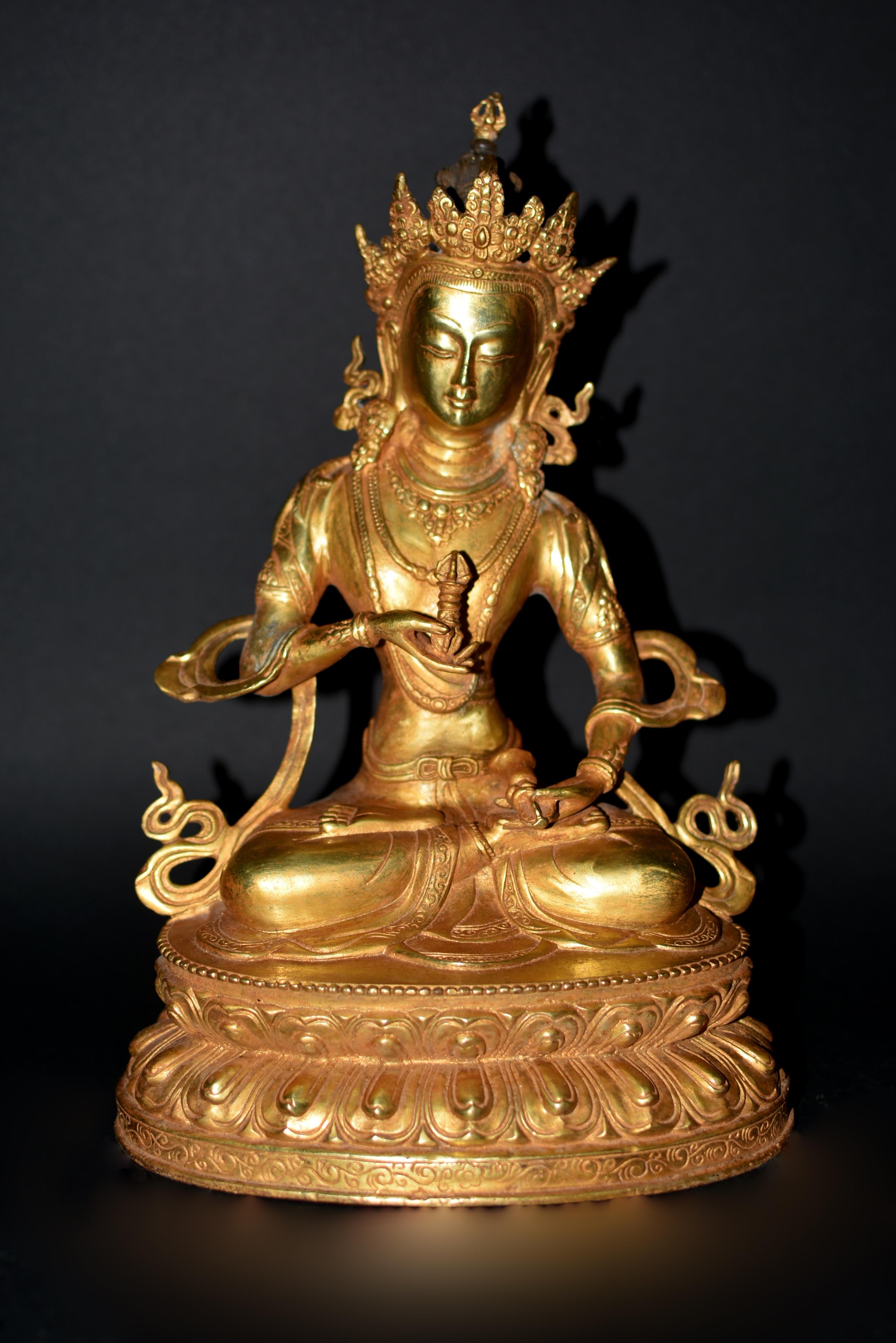 A beautiful, 4.15 lb, gilt bronze Tibetan sculpture of Buddha Vajrasattva. Seated dhyana asana on double lotus throne, in the left hand a ghanta bell, in the right hand a vajra thunderbolt, scepters of combined male and female energy to conquer