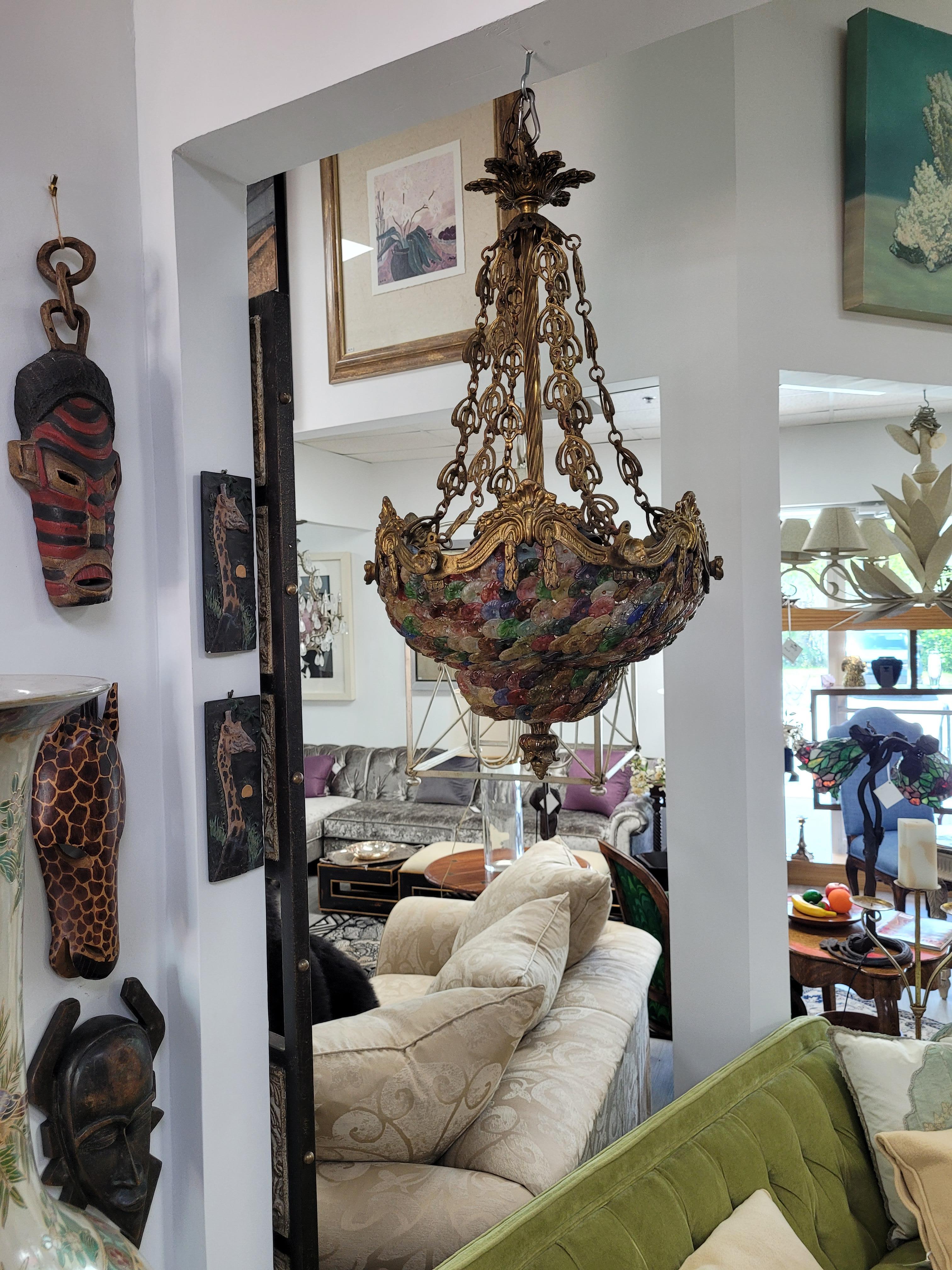 Illuminate your space with the captivating Venetian Chandelier, a true testament to the timeless artistry of Murano glassmaking. This rare fixture dates from the mid-20th century, showcasing the characteristic craftsmanship of its period and
