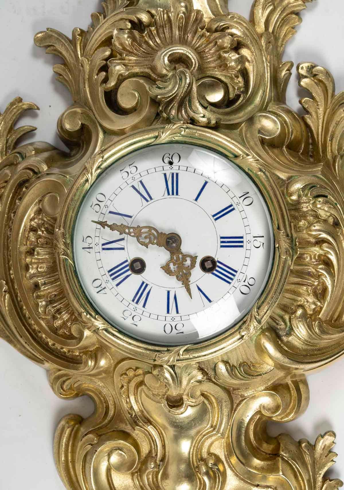 Gilt bronze wall clock, Louis XV style, early 20th century.

Louis XV style wall-mounted gilt bronze cartel, early 20th century, movement to be revised.
H: 80cm, W: 37cm, D: 12cm