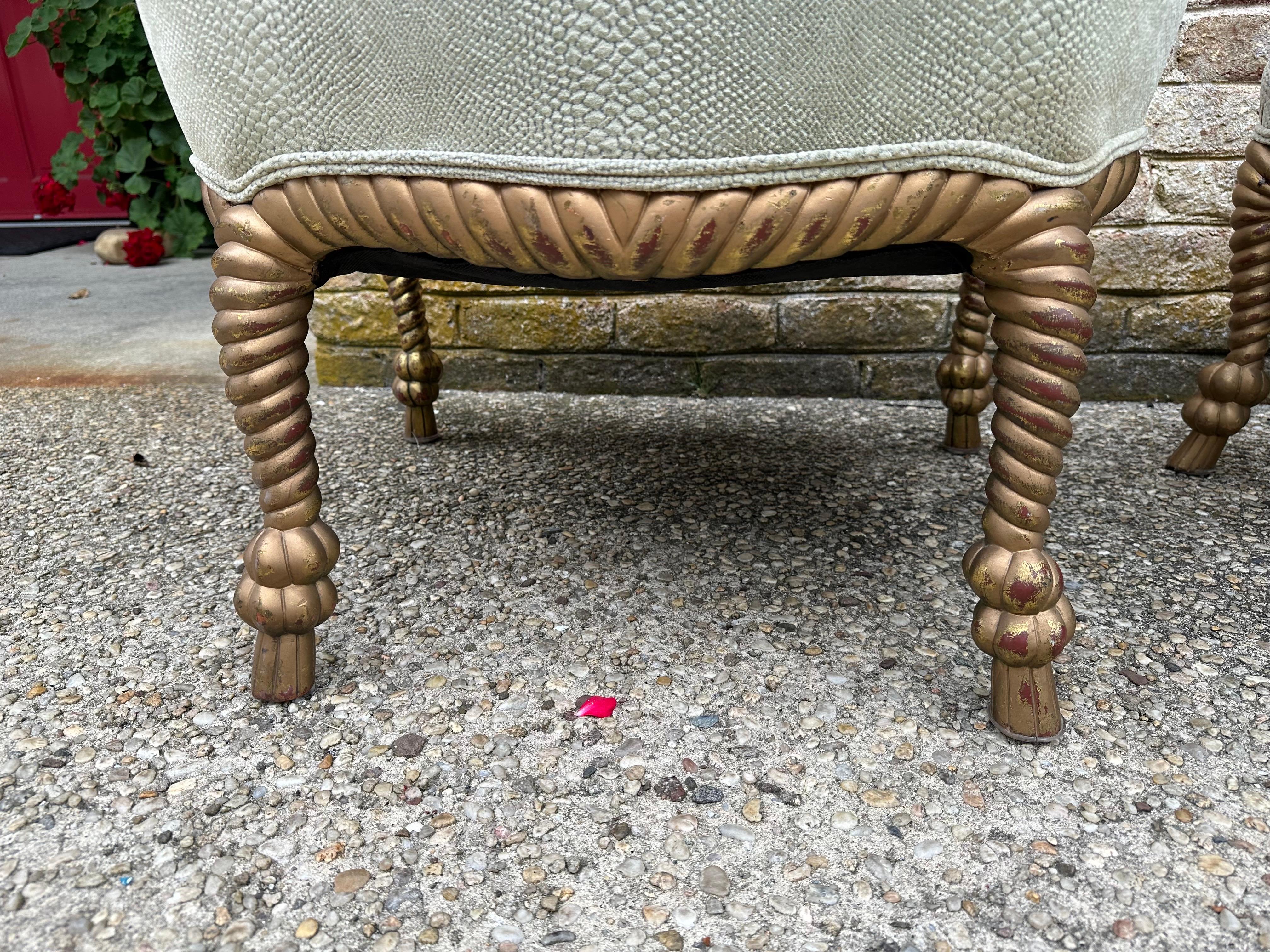 Elegant pair of carved and gilt rope chairs with original upholstery.
