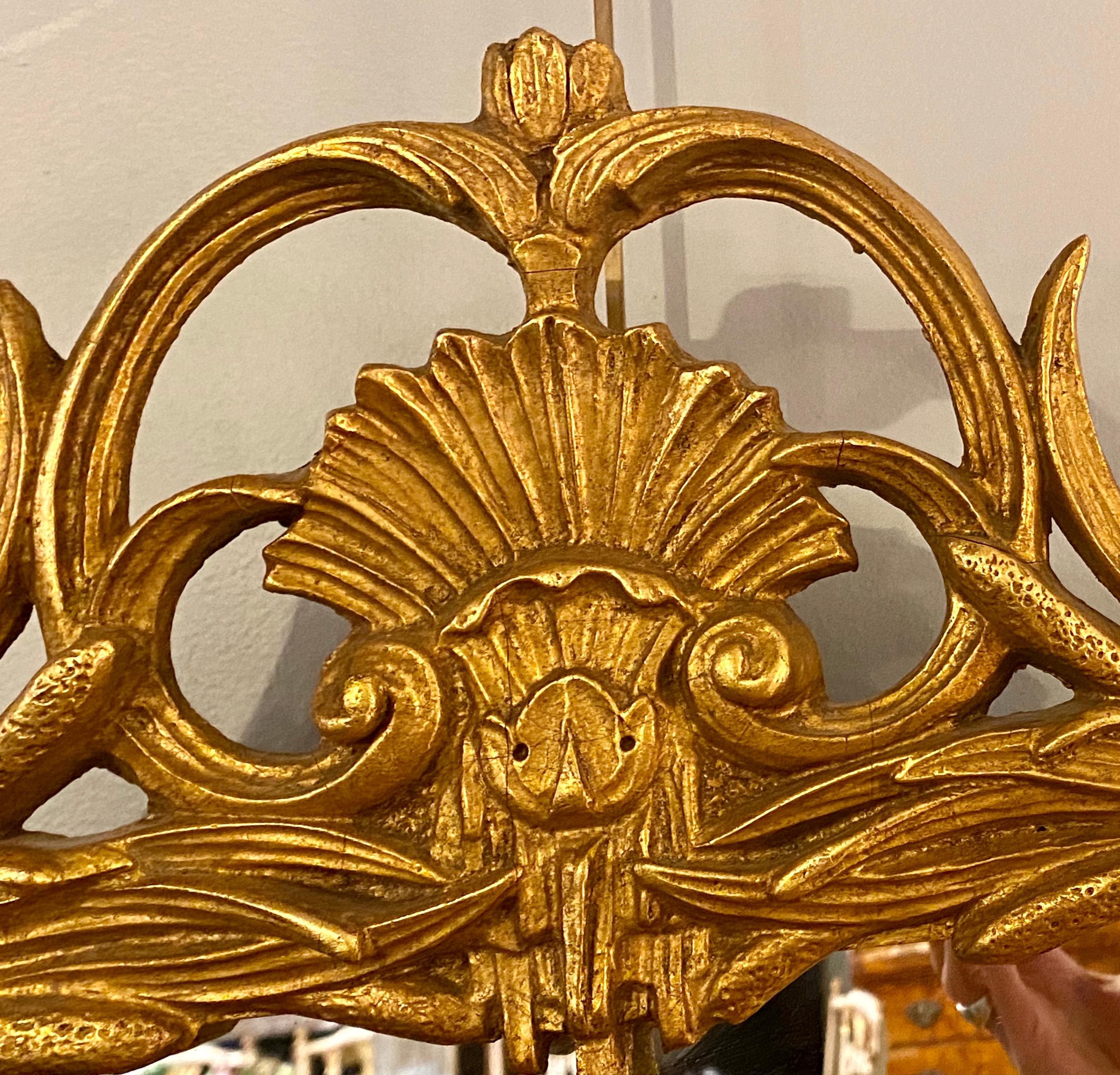 Gilt carved shell motif Italian mirror. Finely carved giltwood frame surrounding a clean center mirror. Rectangular in form.
