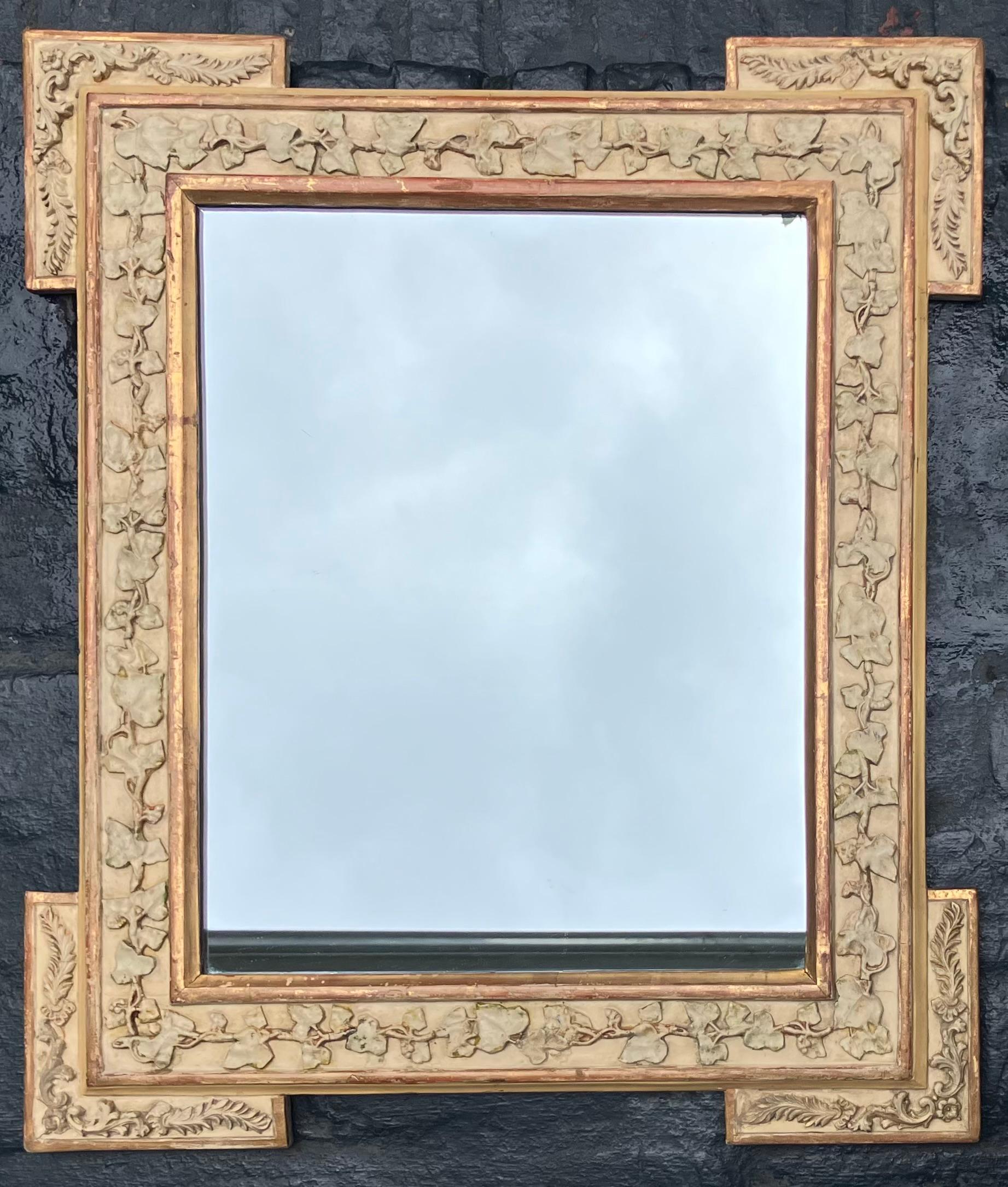 Gilt carved wedding mirror. Antique gilt carved and painted gesso mirror in the mannerist style with painted plaster entwined grape leaves and grape clusters border with gilt edges with later mirror plate. Perfect wedding gift in creams and gold.