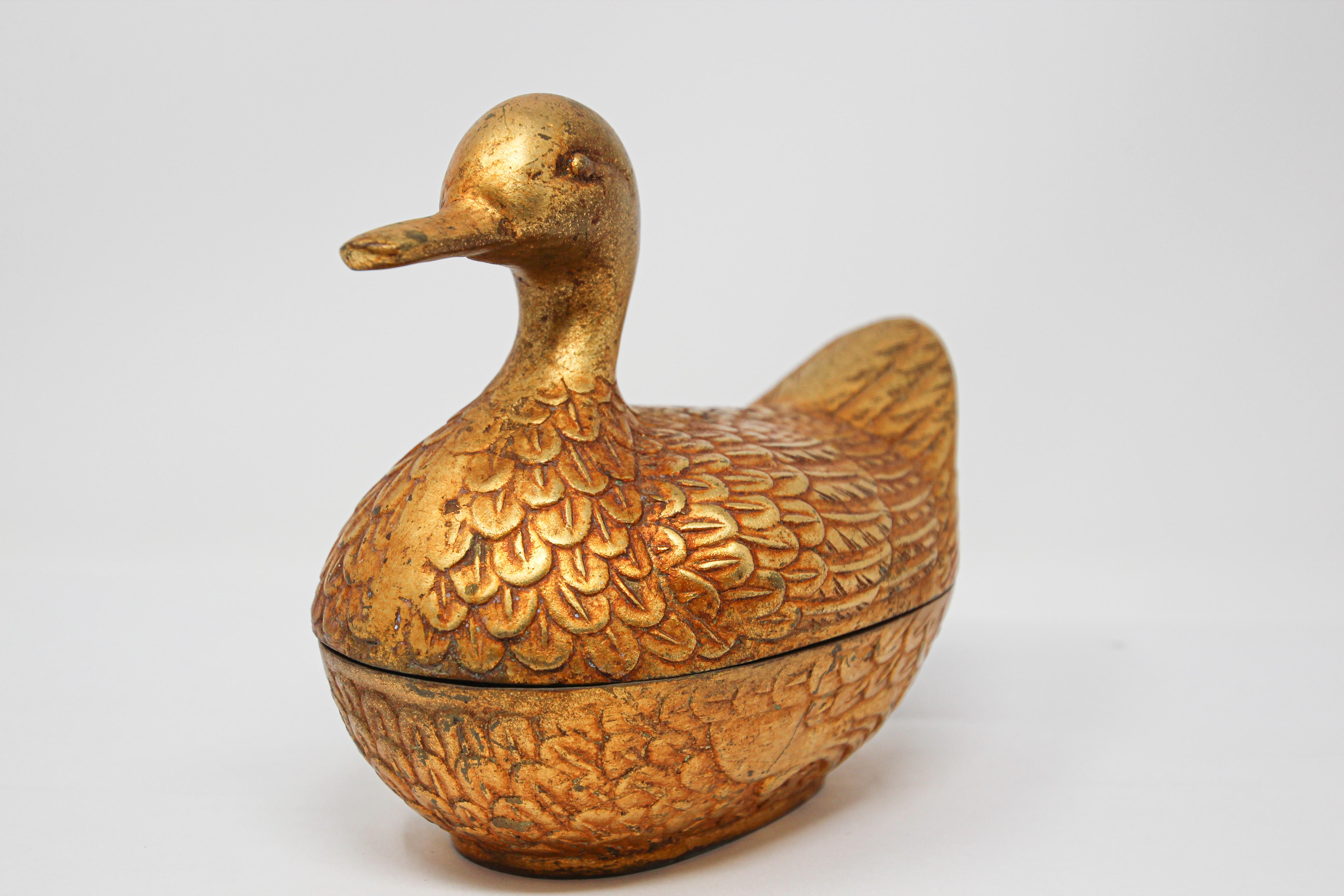 Handcrafted decorative vintage collectible brass nut duck shape trinket box.
Beautiful handcrafted large cast brass bird form box with lid.
Vintage two-piece solid brass figural duck trinket box.
Probably used as a nut box or treasure