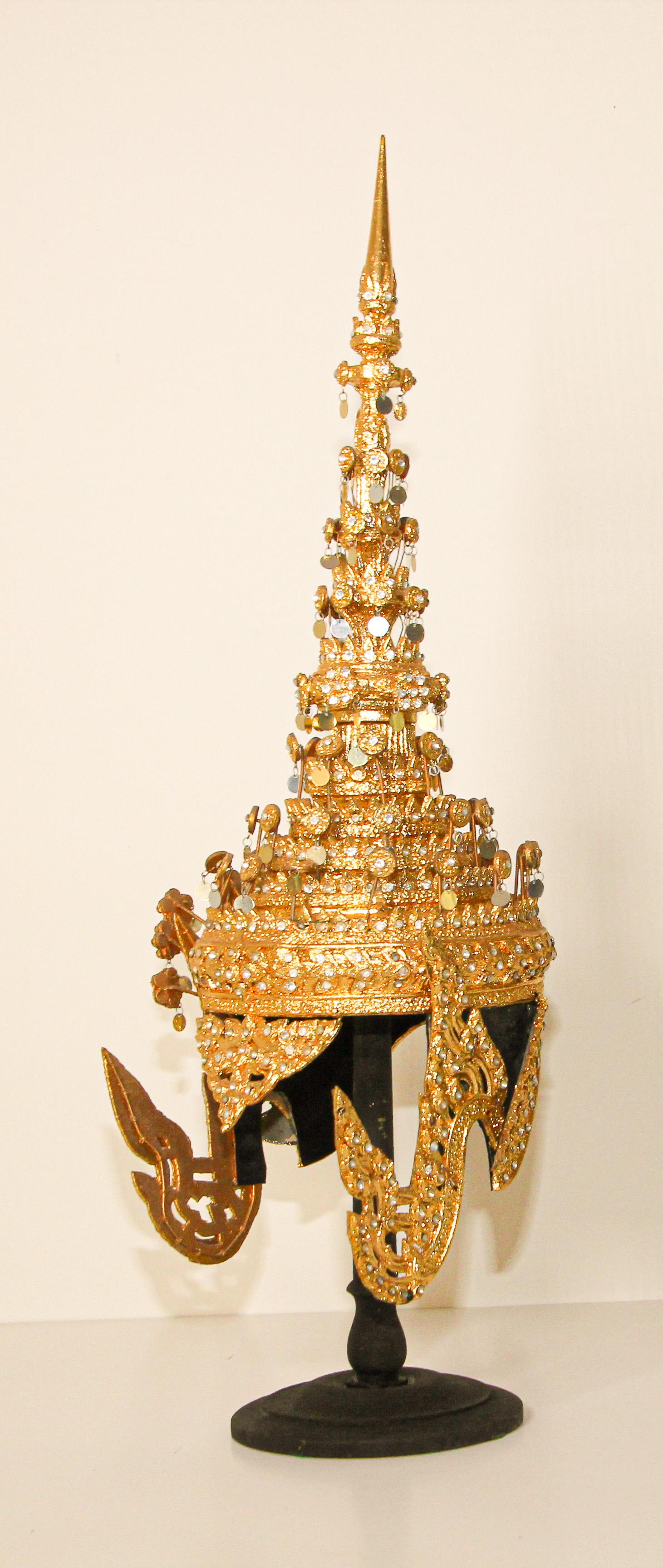Ceremonial Thai headdress usually worn for wedding or religious ceremonies.
Hand-crafted in Thailand.
Gilt Thai Ceremonial Headdress circa 20th century.
A traditionally modeled design with a conical metal spire at the top, in gilt papier mâché,