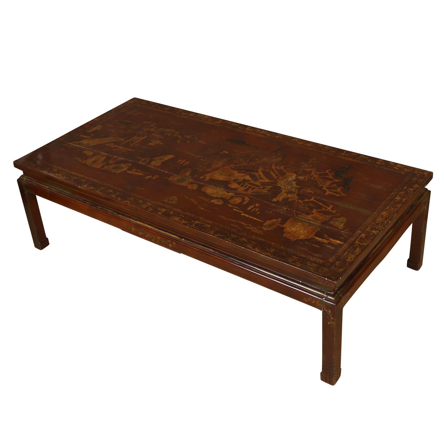 Gilt decorated Asian coffee table in deep lacquered tone with square hoof feet.