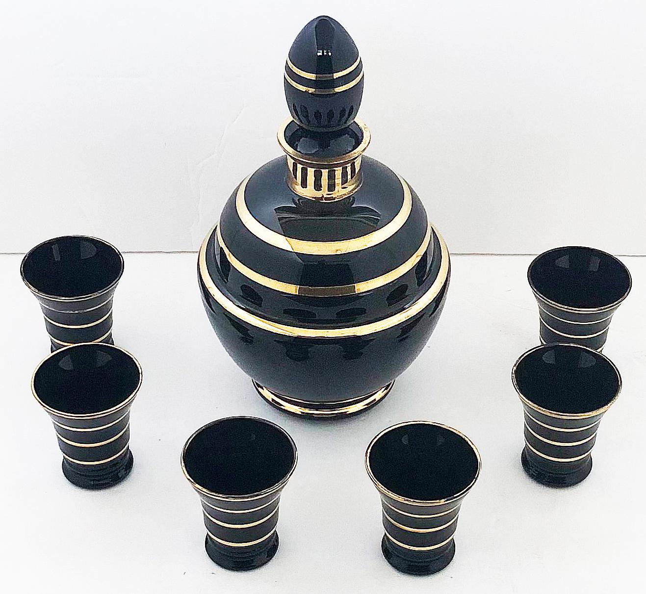 Gilt decorated black bristol glass cordial decanter / glasses, set of 7

Offered for sale is a gilt decorated opaque black Bristol glass cordial decanter set with a decanter, stopper, and six cordial glasses. 

Cups measure 2.13