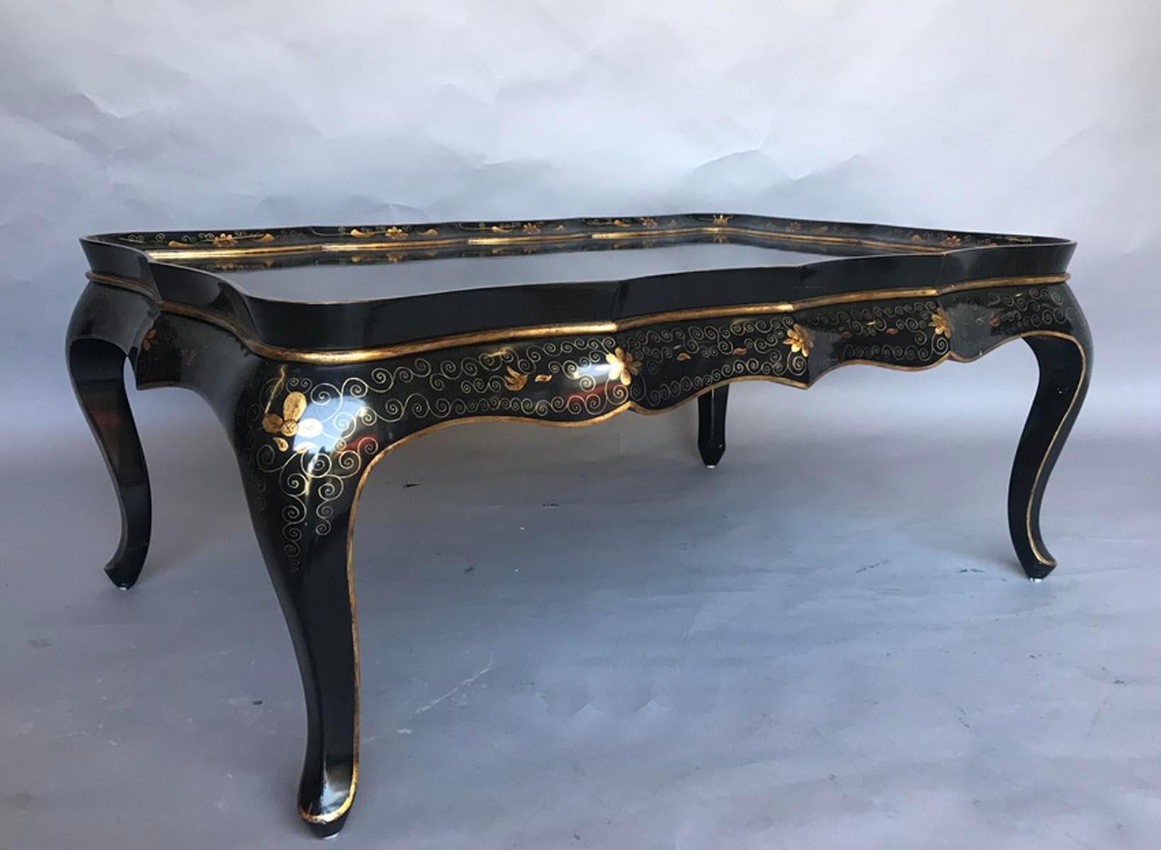 Black gloss coffee table with Queen Anne style legs. Chinese style gold chinoiserie decoration with flowers. Good condition, shows a few signs of use but doesn’t not detract from the beauty or function.