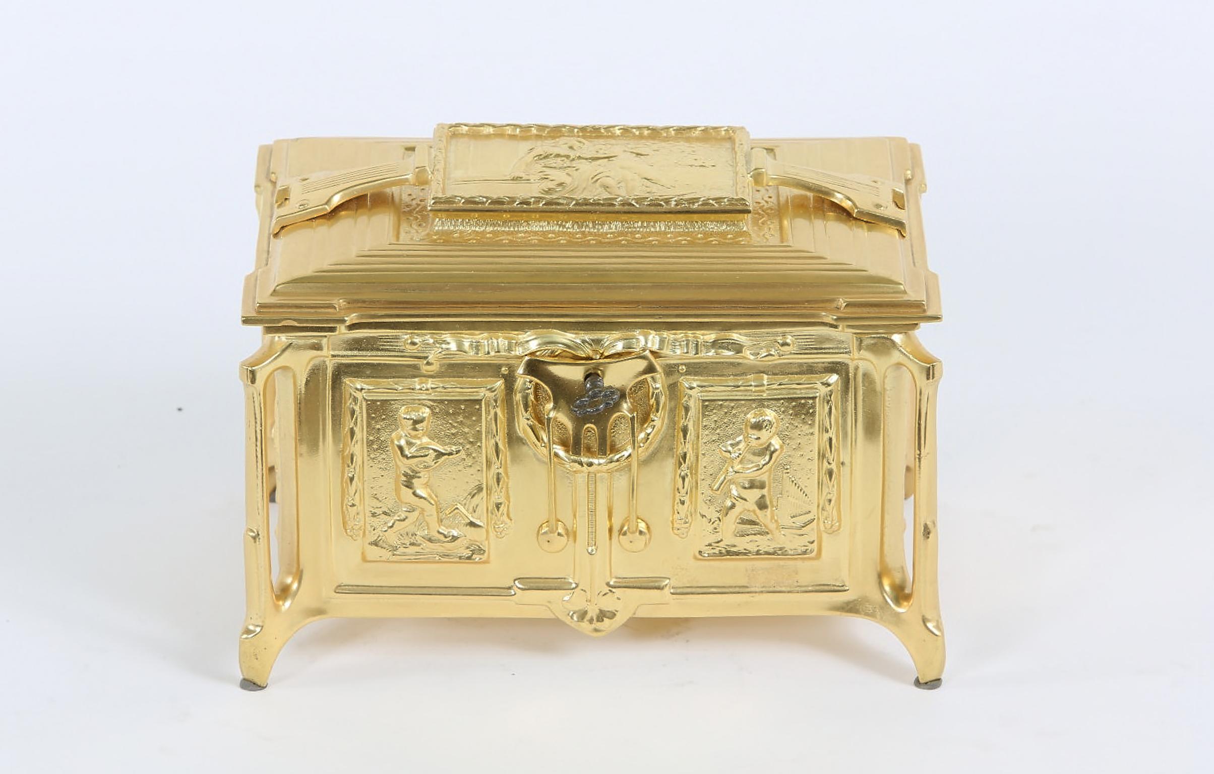 Gilt Dore bronze metal footed covered decorated box with exterior design details and silk interior. Top cover lid with scene of seated lady & putti. Regilded & maker's mark stamped undersigned with front key. The covered box is about 8