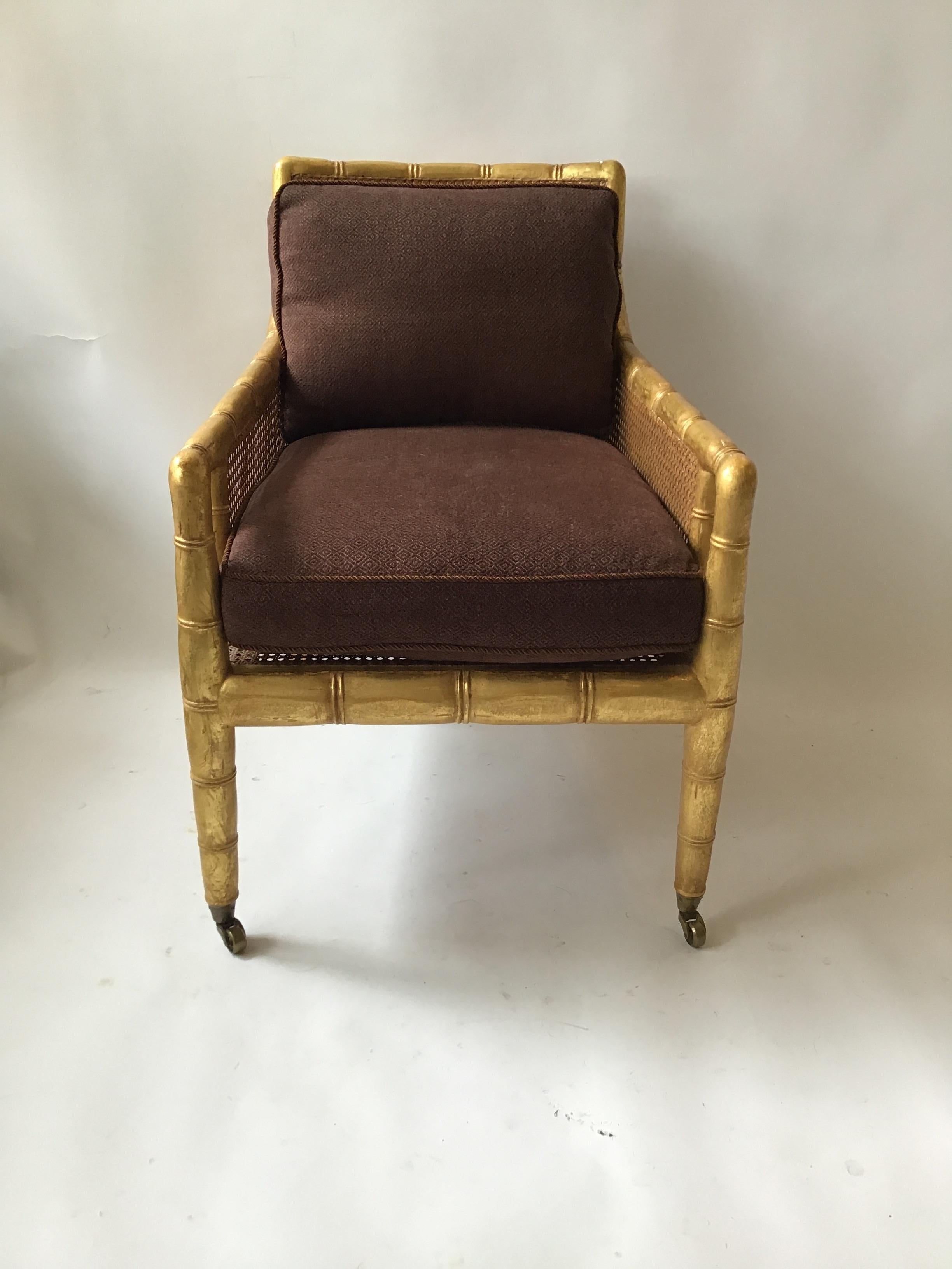 Gilt faux bamboo caned lounge chair. From a Southampton, NY celebrities oceanfront estate.
