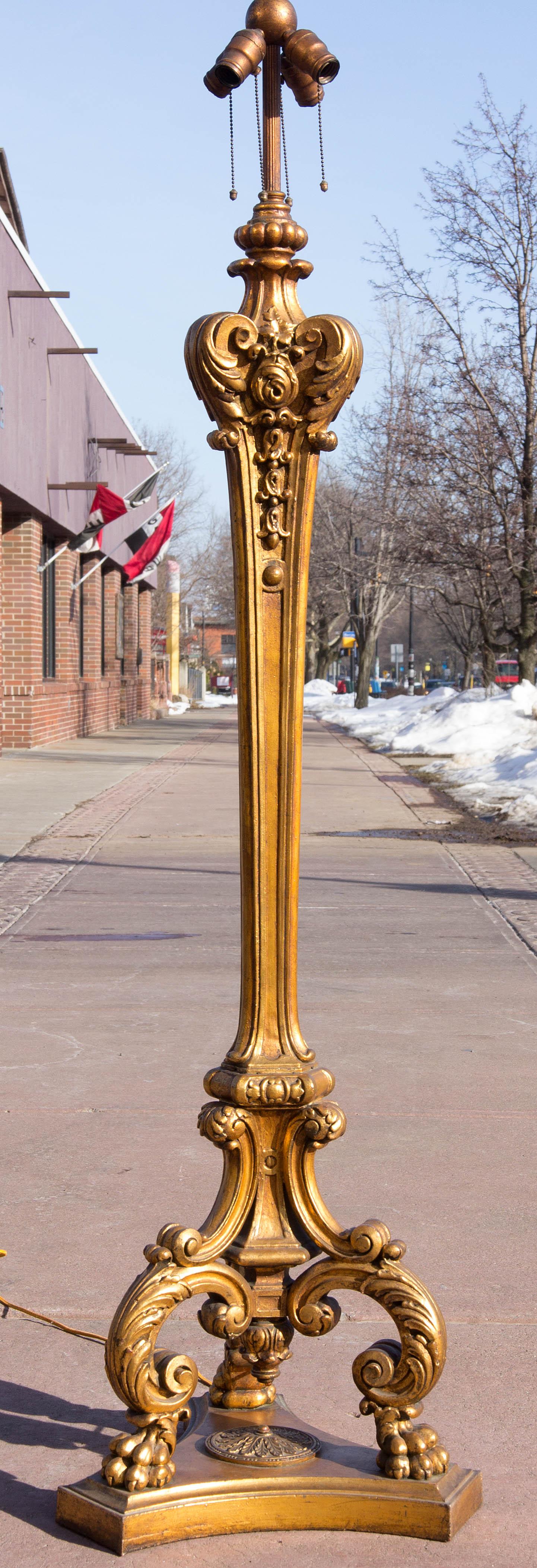 Antique Baroque style gilt floor lamp. Gilt bronze clad composition. Heavy duty construction. Will hold silk or glass shade. Four-light sockets, circa 1920. Measures: 67