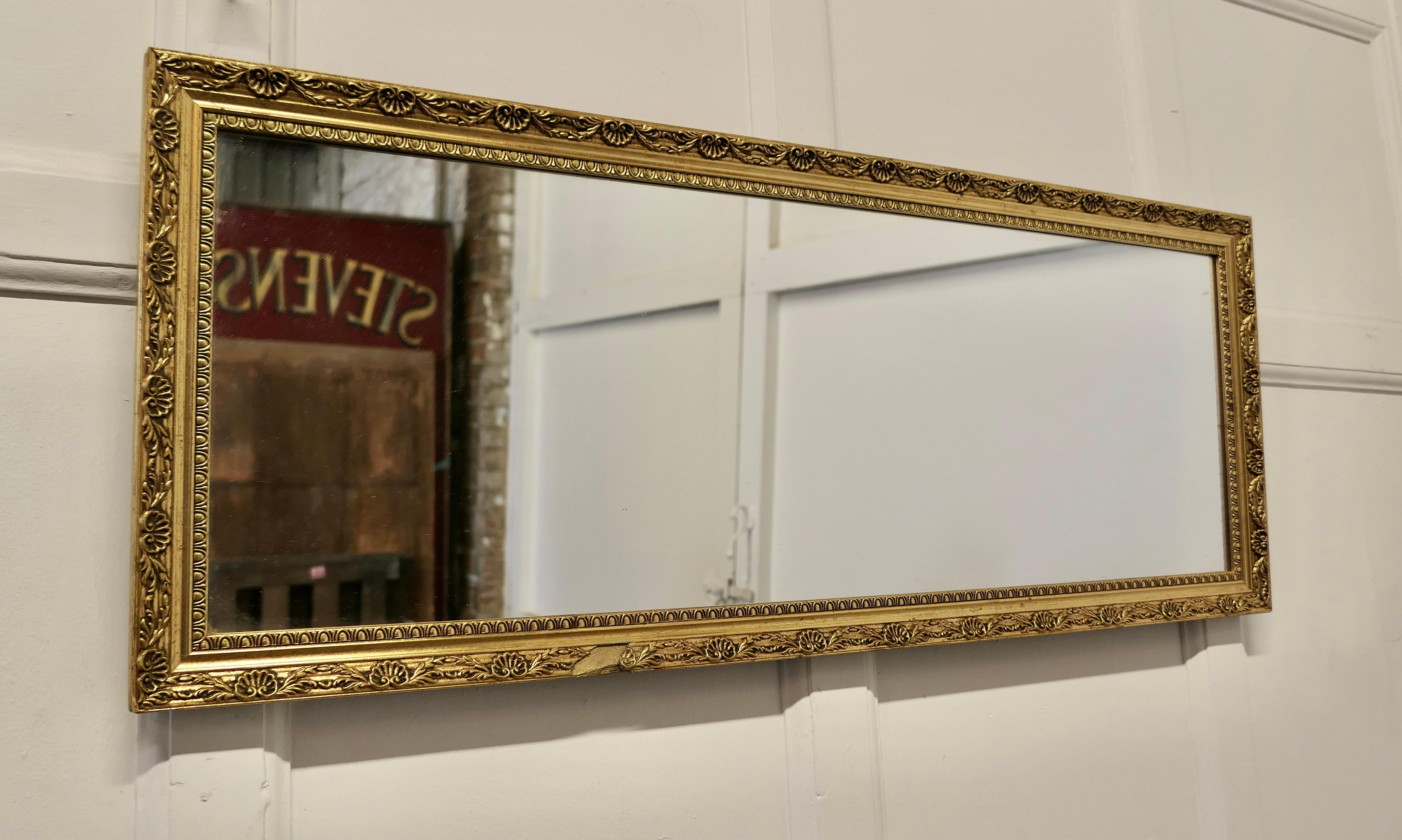 Gilt frame long wall mirror

This is a charming and elegant piece, it is unusually long and landscape the bright Gilt mirror frame is 2” wide and is very attractive 
The piece is in good condition but for a small piece on the front of the frame’s