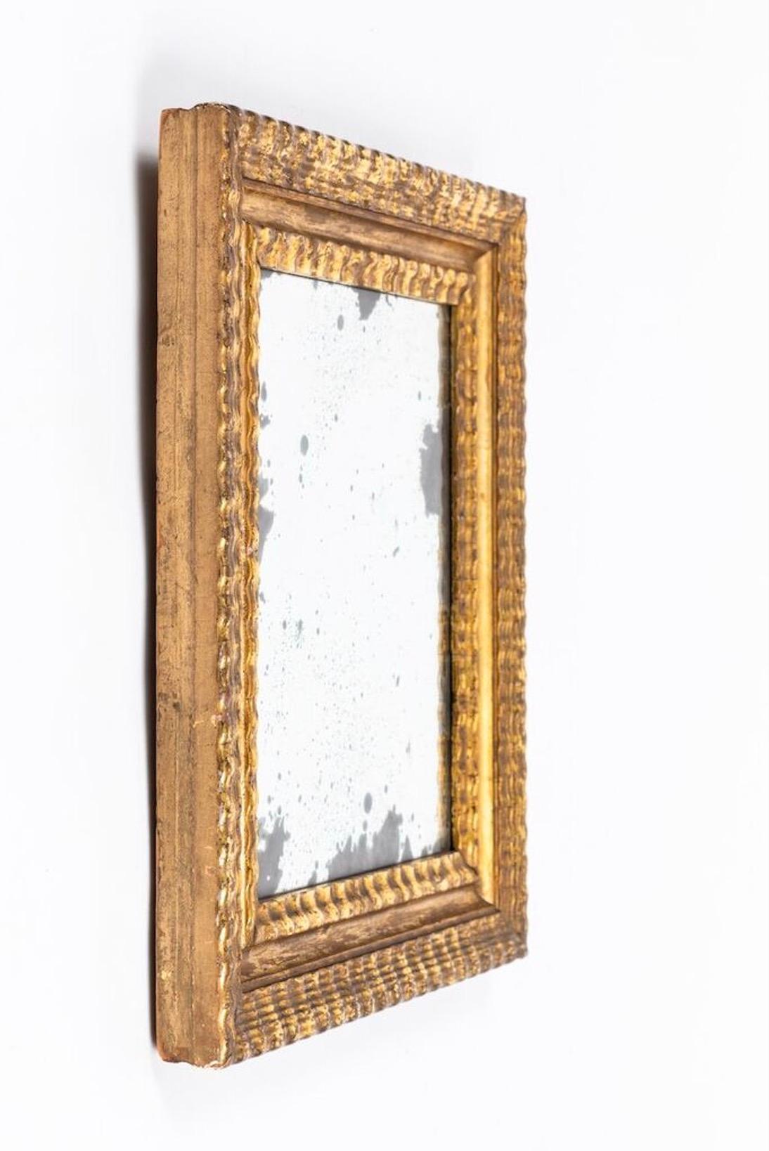 17th century Dutch Baroque mirror, with gilt frame. Rectangular small scale with textured frame. Original glass with natural antiqued appearance.

 