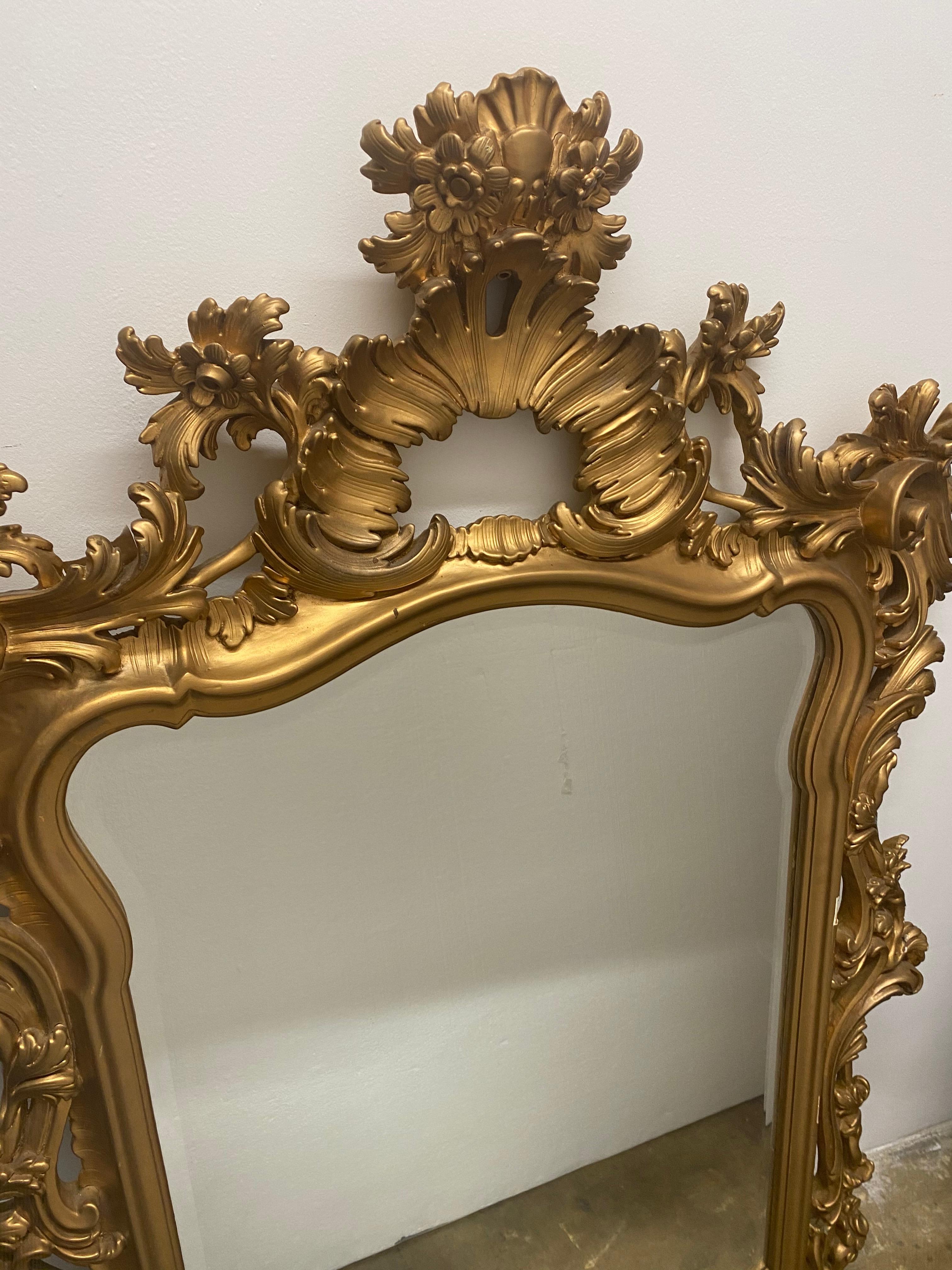 Gilt framed beveled glass mirror, it has gold paint over the old gilt below.