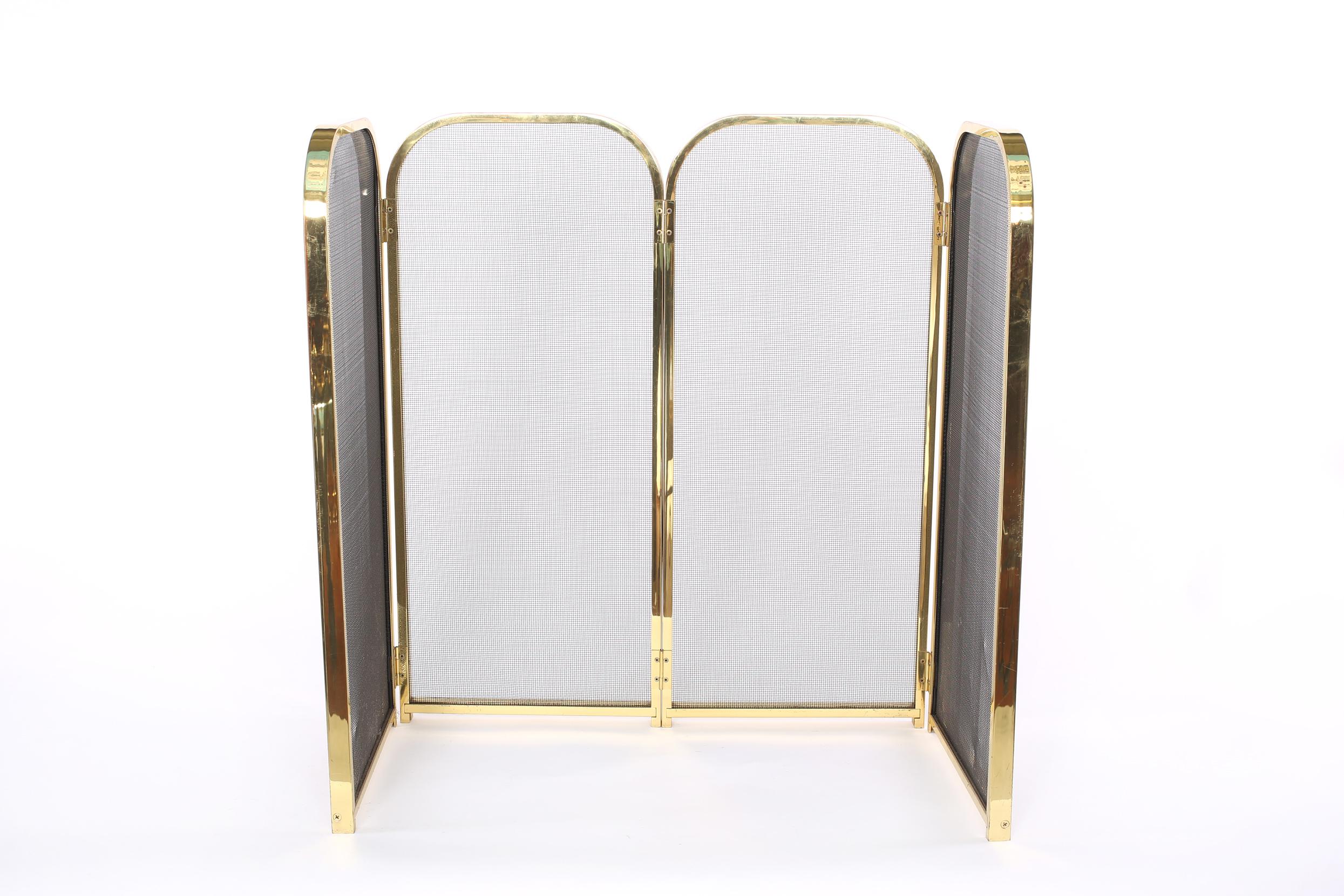 Mid-Century Modern gilt brass Framed with interior black mesh four panels fire place screen. The fire screen Stand about 27 inches high x 12 inches deep x 27 inches wide. Front panel is 26 inches / side panel 12.5 inches.