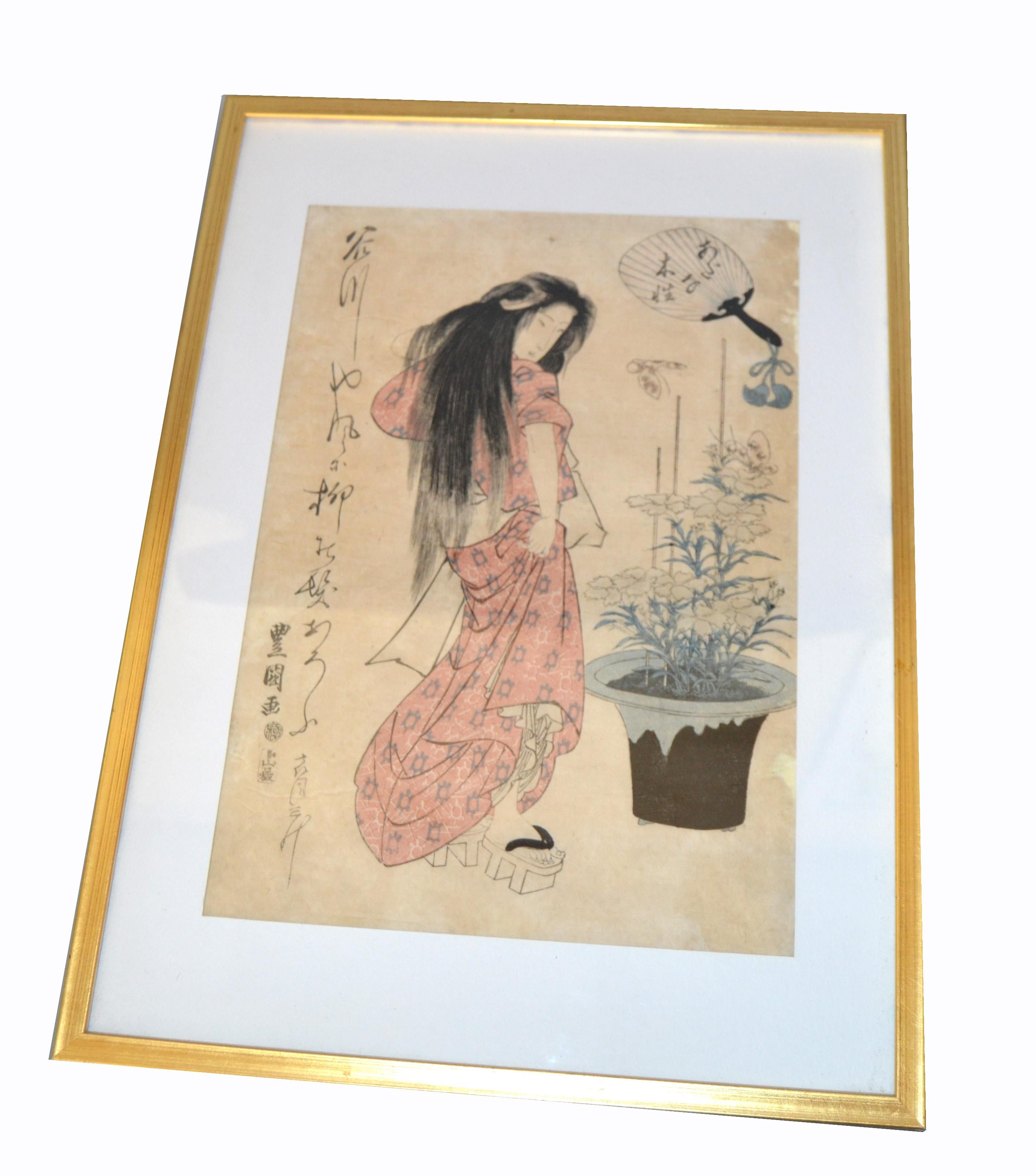 Original Utagawa Toyokuni II Geisha Japanese woodblock print on parchment paper in gilt frame.
Marked by Artist: Utagawa Toyokuni II (1777-1835) and dated circa 1810.
    