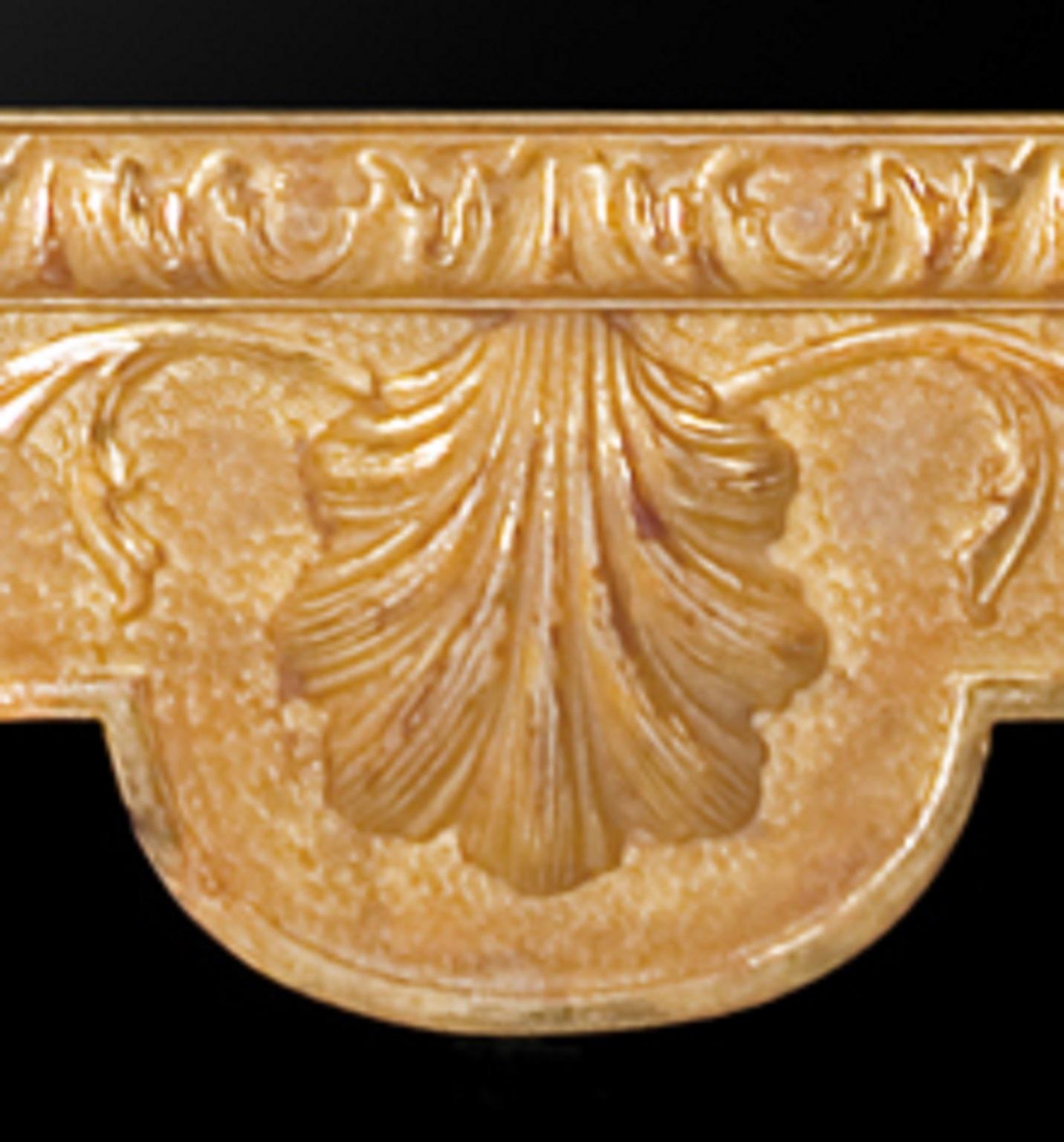 A George I style carved giltwood and gesso looking glass mirror. The rectangular mirror plate is in a leaf and shell carved moulded frame beneath a shaped cresting centered by a pierced plume on a moulded plinth. The textured groundwork is