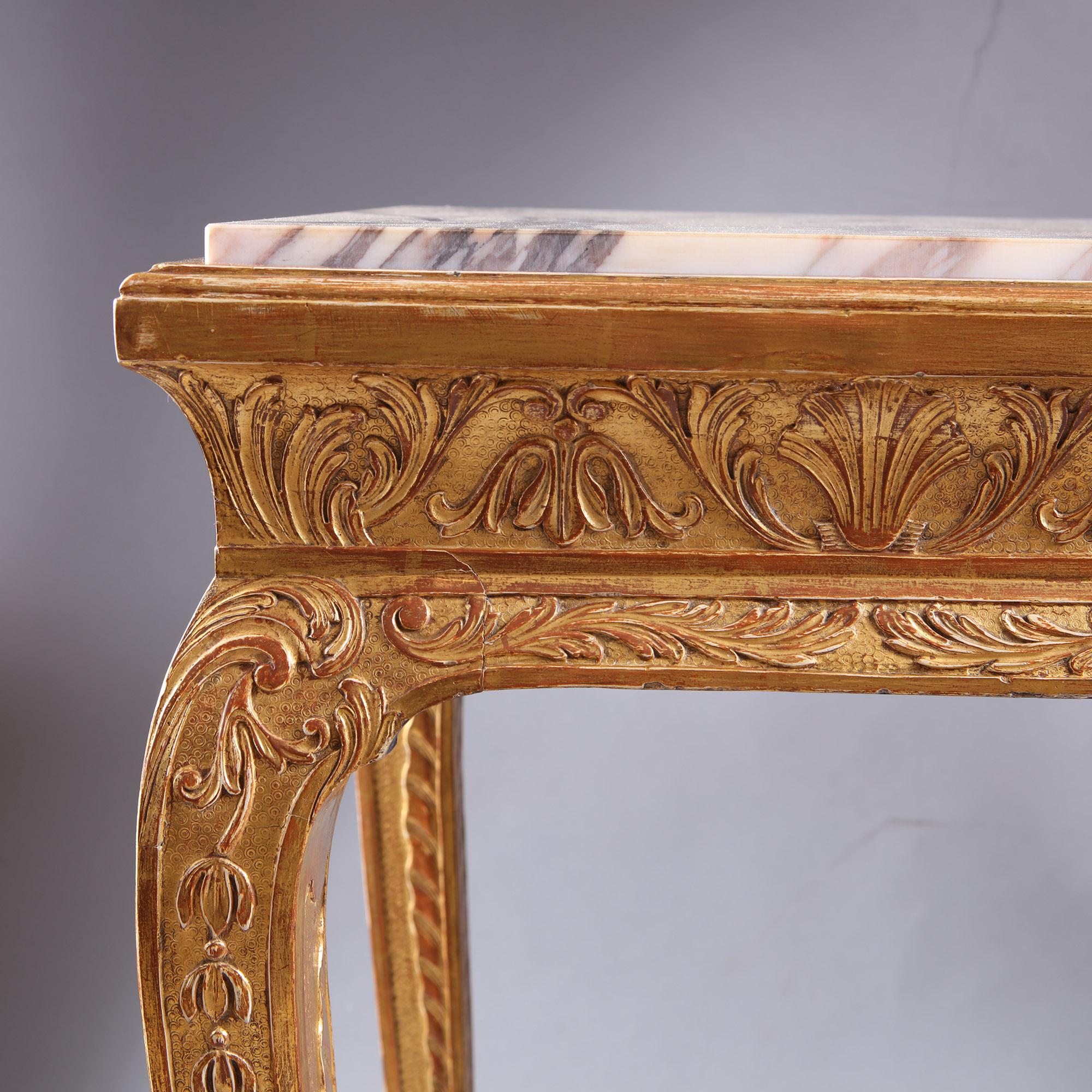 This 19th century carved gilt Gesso side table with marble top is a stunning piece of furniture in the early 18th century style. It features a beautiful marble top, with intricate carvings and gilt gesso accents. The table is made from high-quality