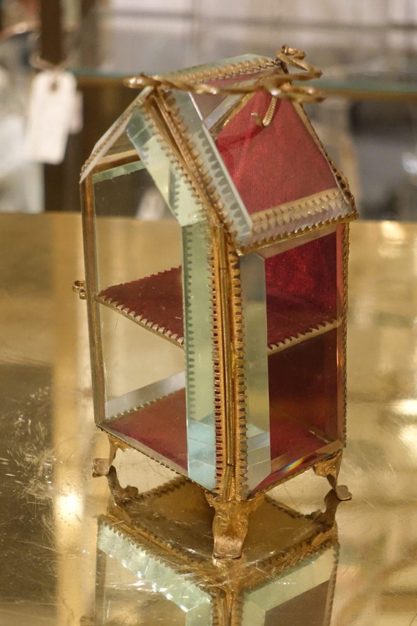 Charming little glass and gilt box, raised on lovely feet, with two miniature shelves and a little handle, and with artfully facet-cut sides of crystal glass. Dates back to the Napoleon III era in midcentury France.

Would originally have been a