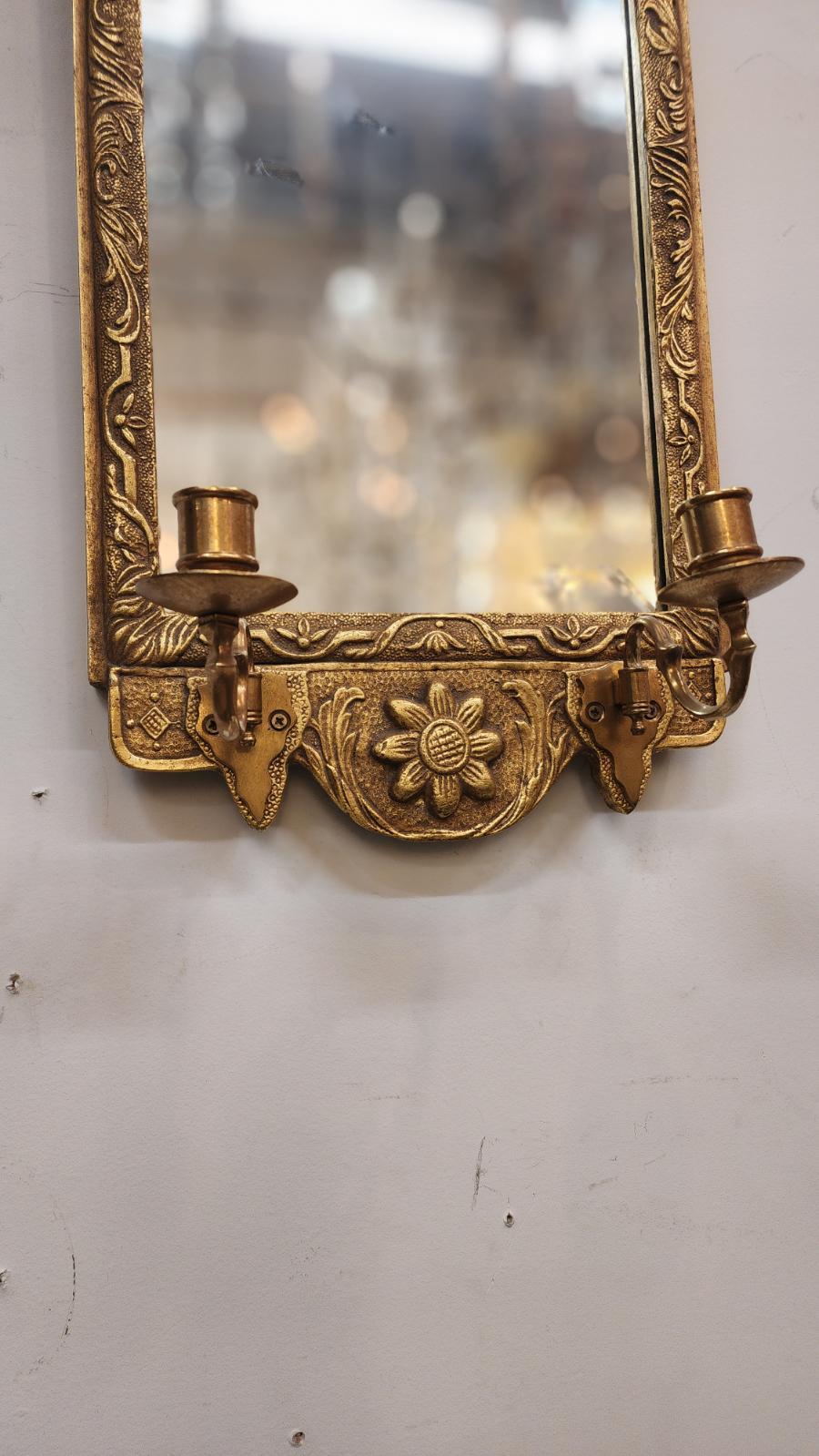 Espejo de pared dorado finamente tallado y detallado.