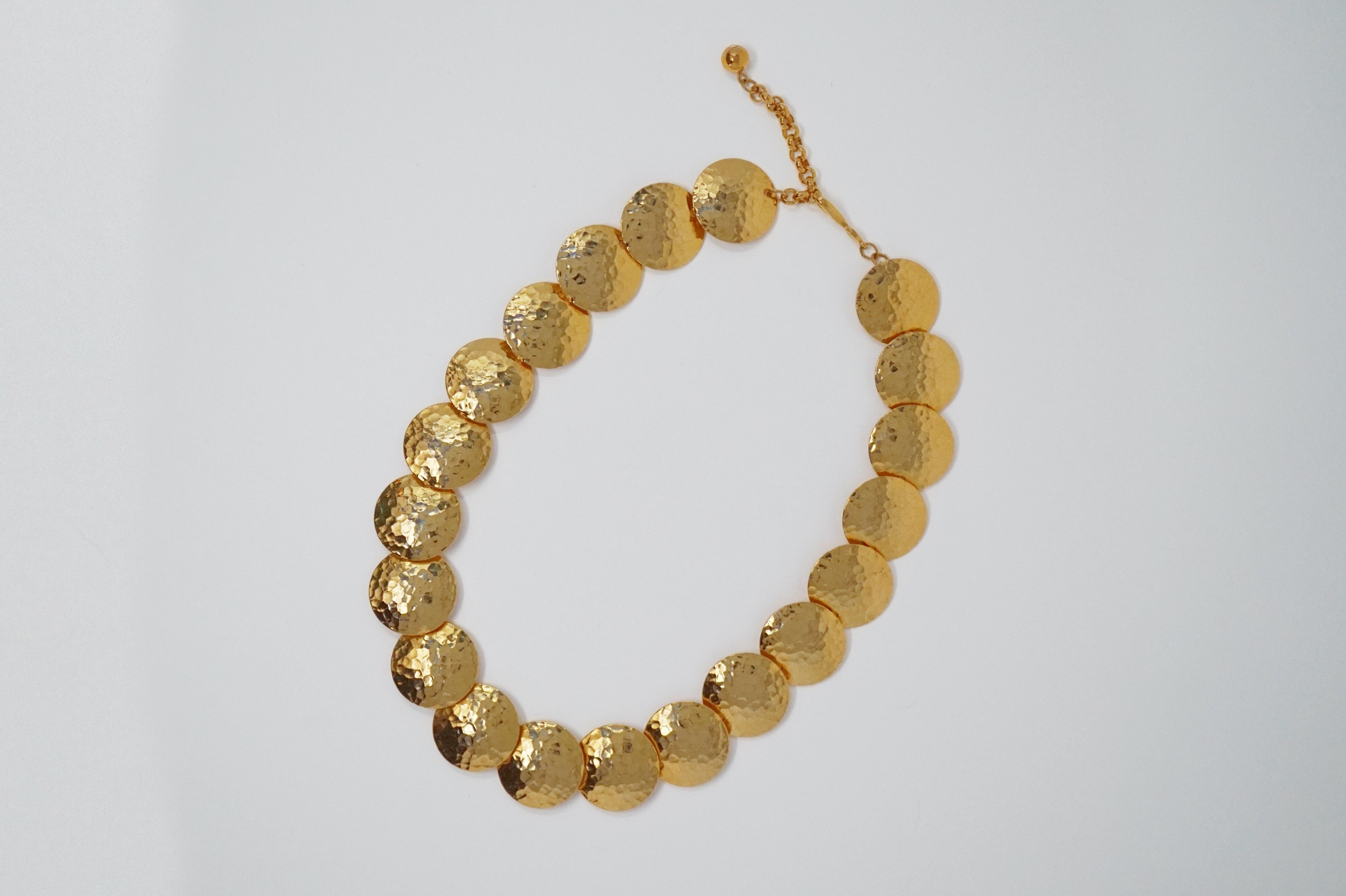 This chic gilded hammered disc statement necklace by Napier, circa 1980, makes a bold statement!  A wonderful resort wear accessory, this piece would pair perfectly with a kaftan or printed maxi dress.

ABOUT NAPIER:
Founded in 1875, Napier is an