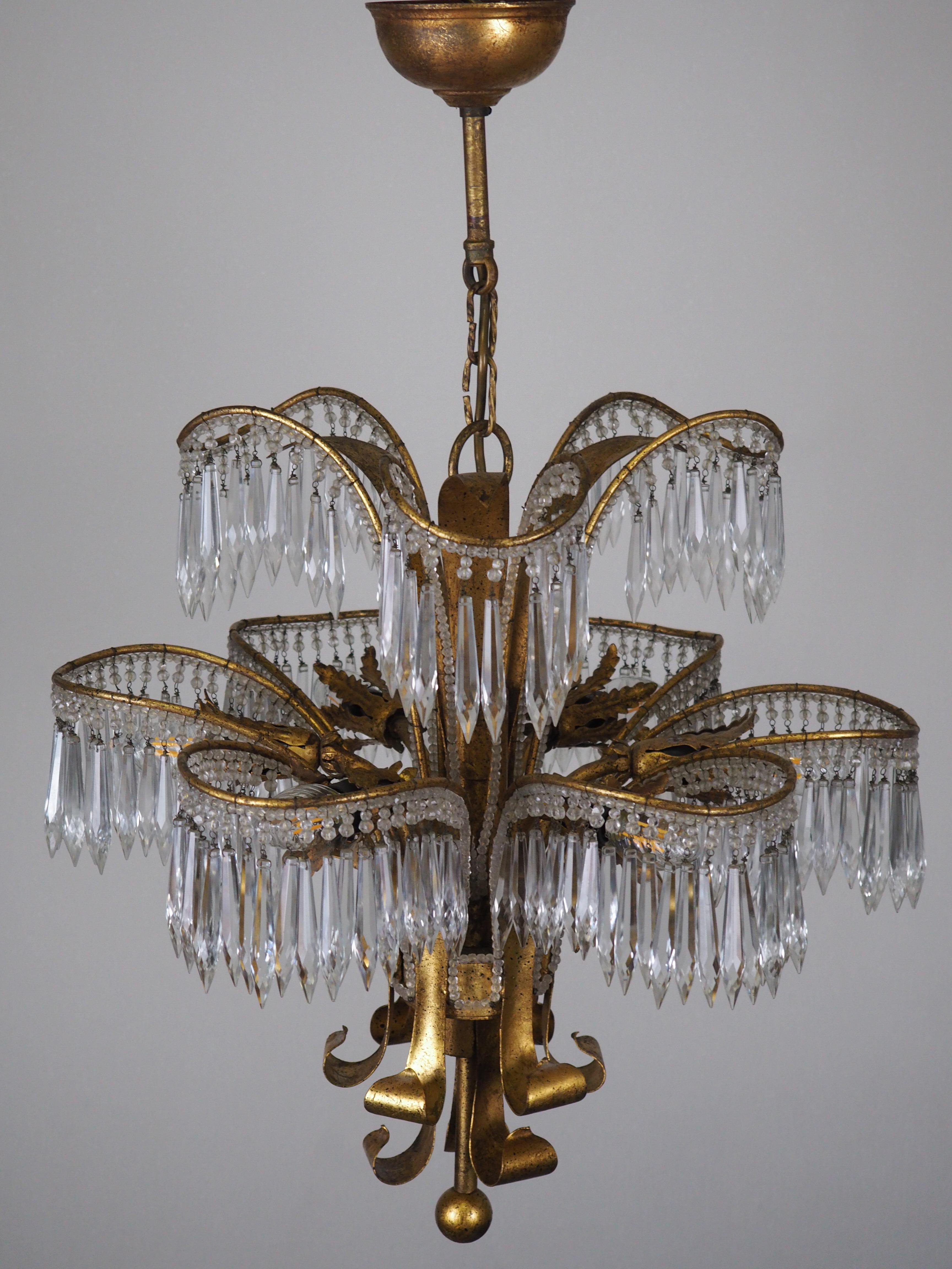 A wonderful beaded gilt iron and cut-crystal palm tree chandelier, Italy, circa 1970s.
Socket: 6 x e14 (Edison) for standard screw bulbs.
The condition is excellent.
 
  