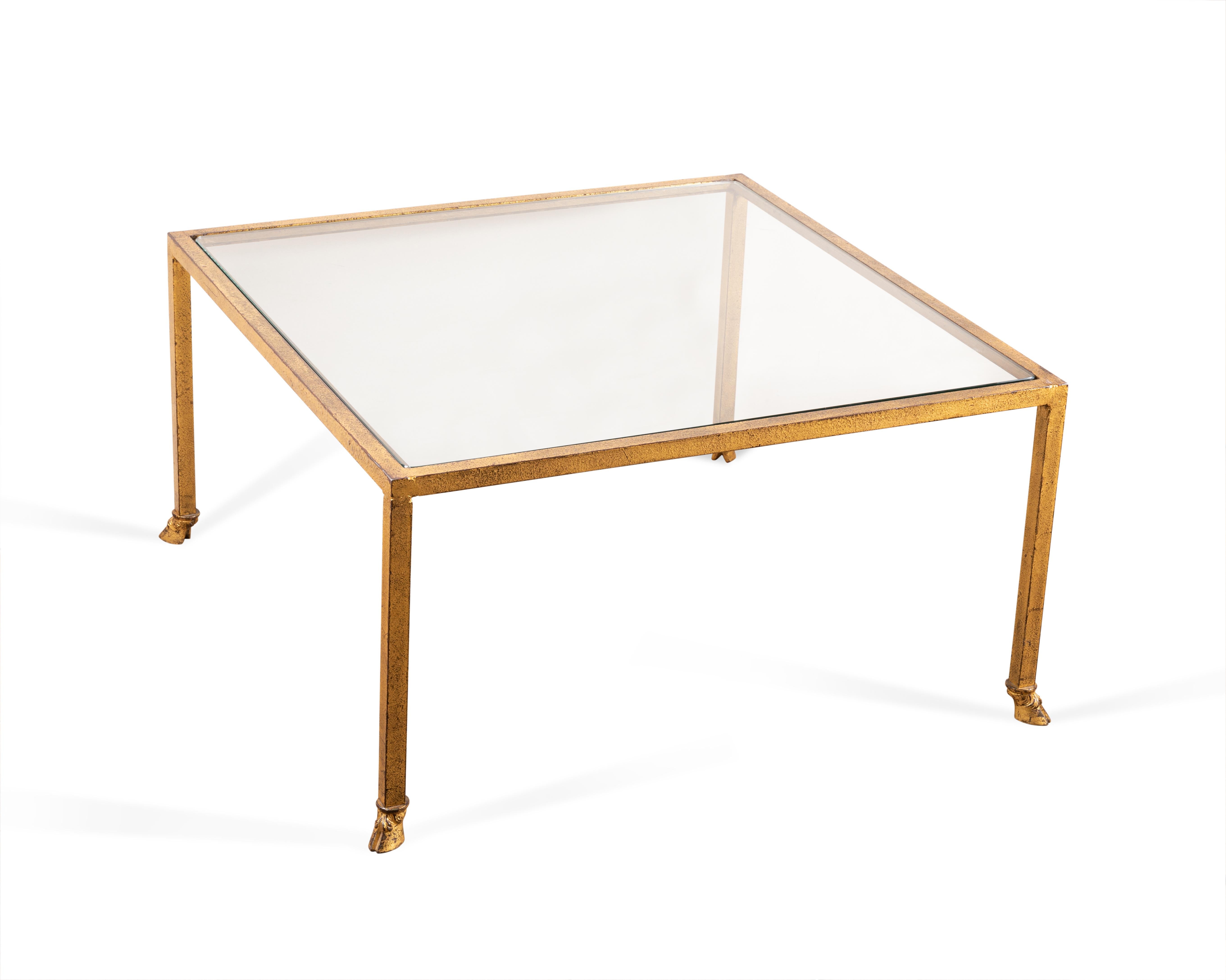 Square coffee table in gilded wrought iron.
Glass top. 
 by Maison Ramsay. 
France
1950

Maison Ramsay produced metal work in the 1950s and 60s, often retailed by Jansen. Ramsay's style is inspired by neoclassicism, as with this coffee table.
