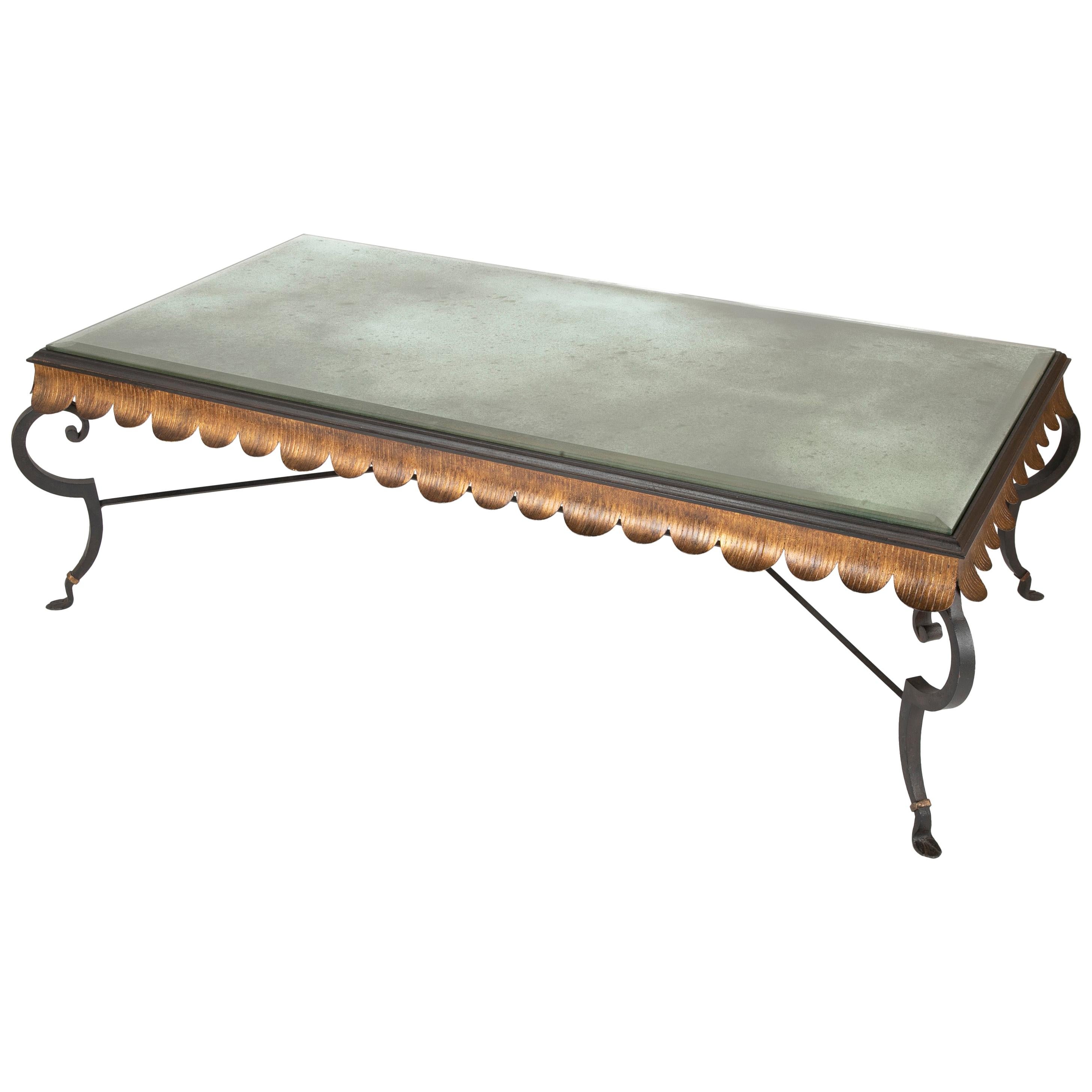 Gilt iron coffee table with custom antiqued and beveled glass top by Minton Spidell.