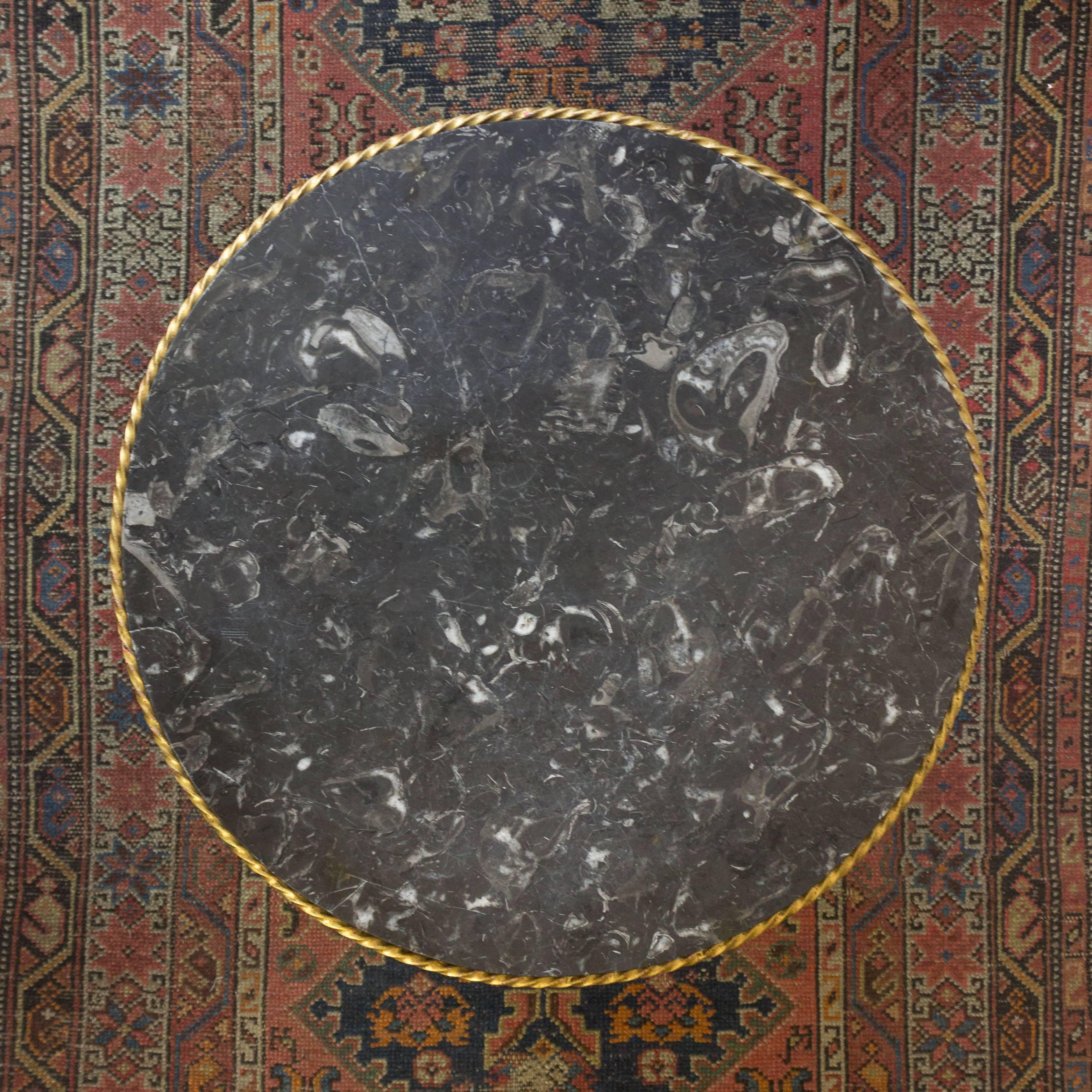 Questo tavolino francese degli anni '40 presenta una base in ferro battuto dorato con un elegante design a volute. La base in ferro ha una ricca patina dorata che aggiunge un tocco di lusso all'insieme.

Il tavolo è sormontato da un bellissimo piano