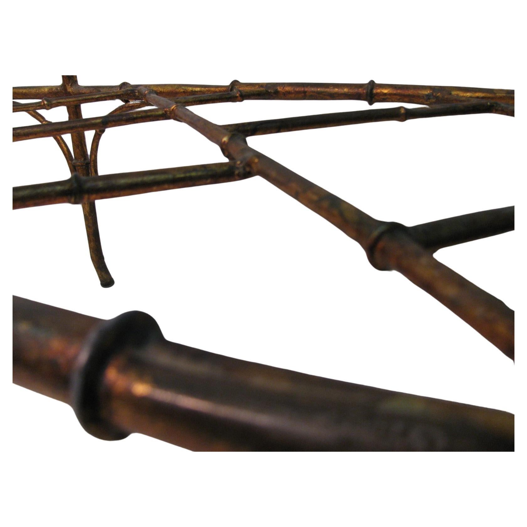 Favoloso tavolo da cocktail a sei gambe in finto bambù della metà del secolo scorso. Design elegante e semplice, ben realizzato, con un ripiano a croce sottostante. Il giusto grado di patina, in quanto la doratura si è ammorbidita e invecchiata. In