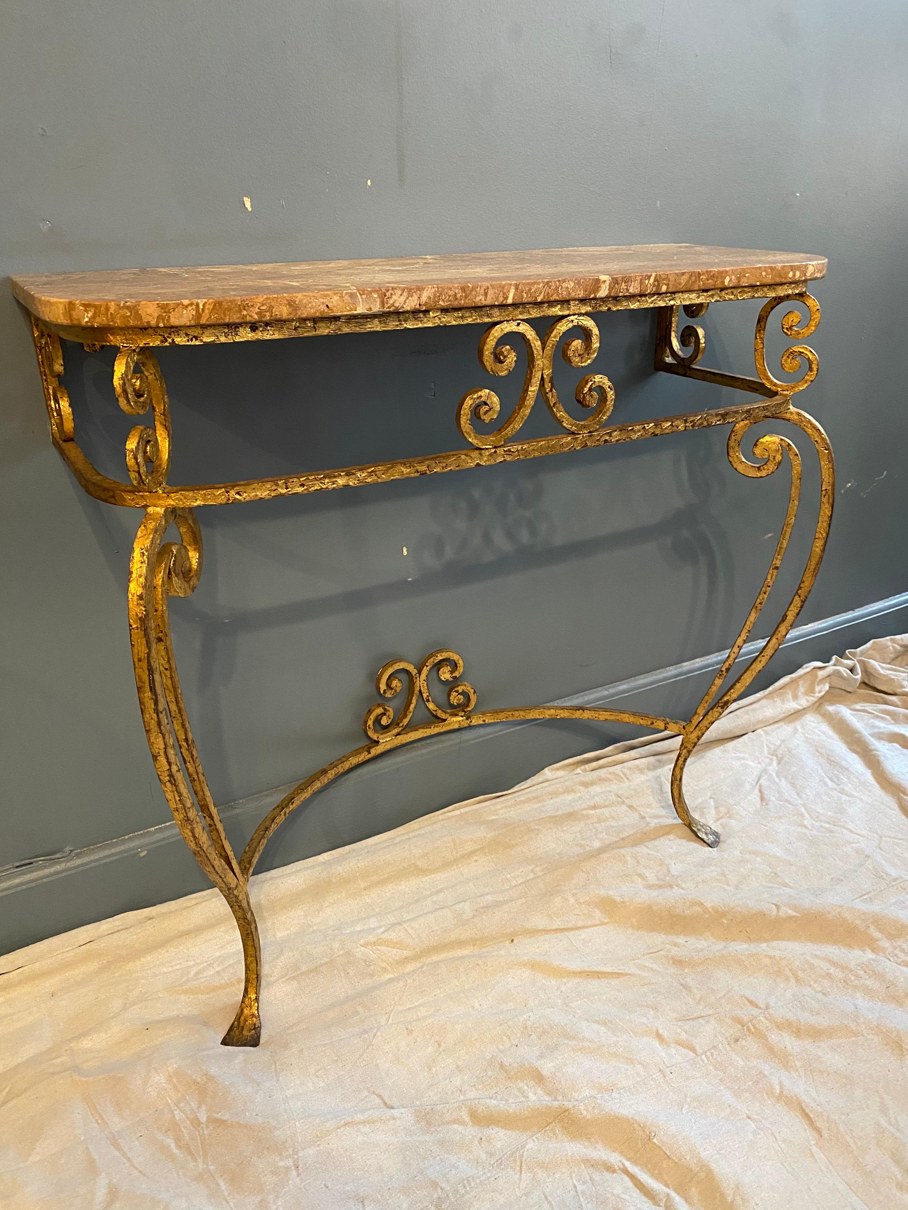 Nice gilt iron Italian marble topped console and matching mirror. Perfect for your entrance or hallway! Gilt is in great shape with minor losses to finish. Marble top has a chip to back right side and there are areas where marble was filled, but