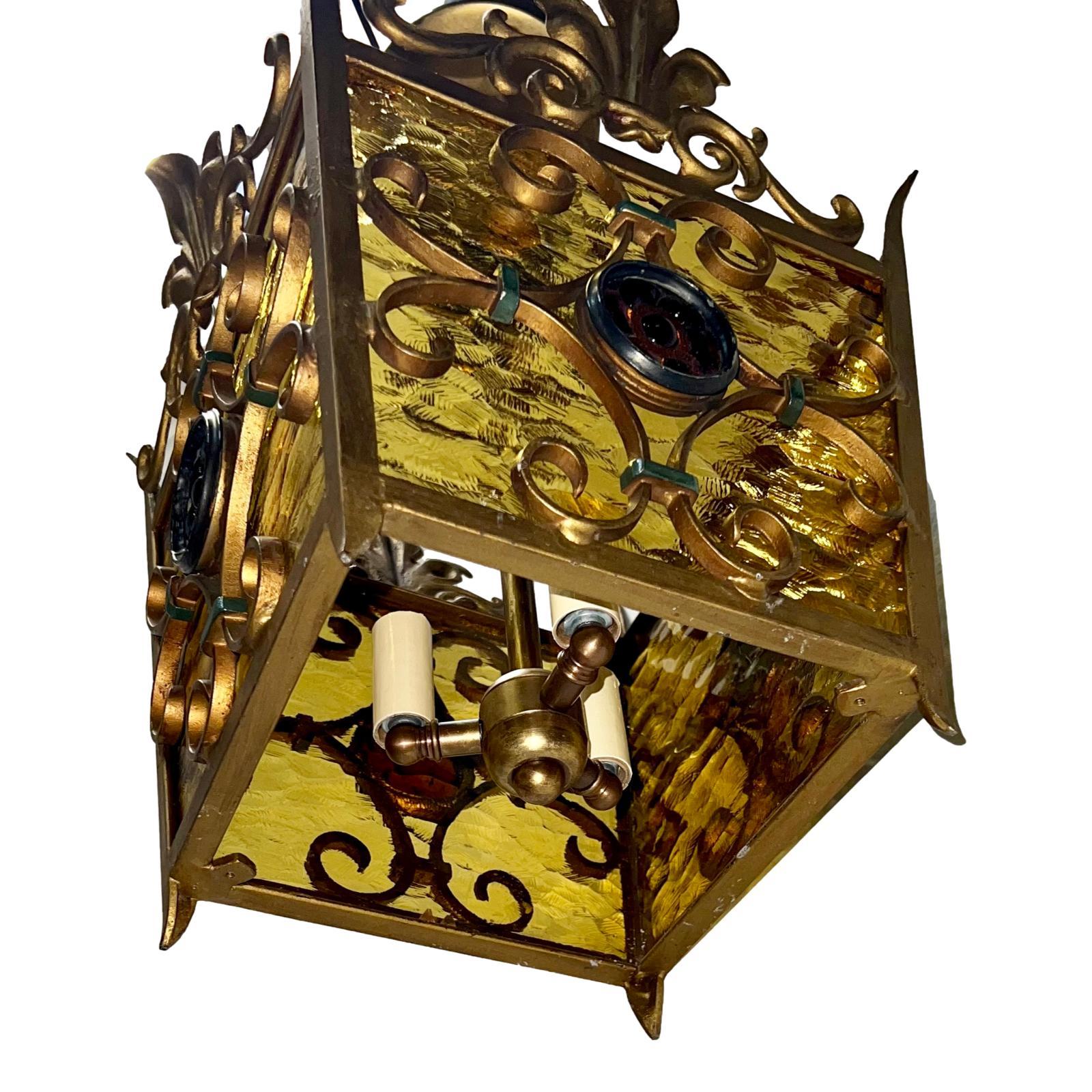 An Italian circa 1950’s gilt iron lantern with blown glass insets.

Measurements:
Drop: 19?
Length/width: 11? square.