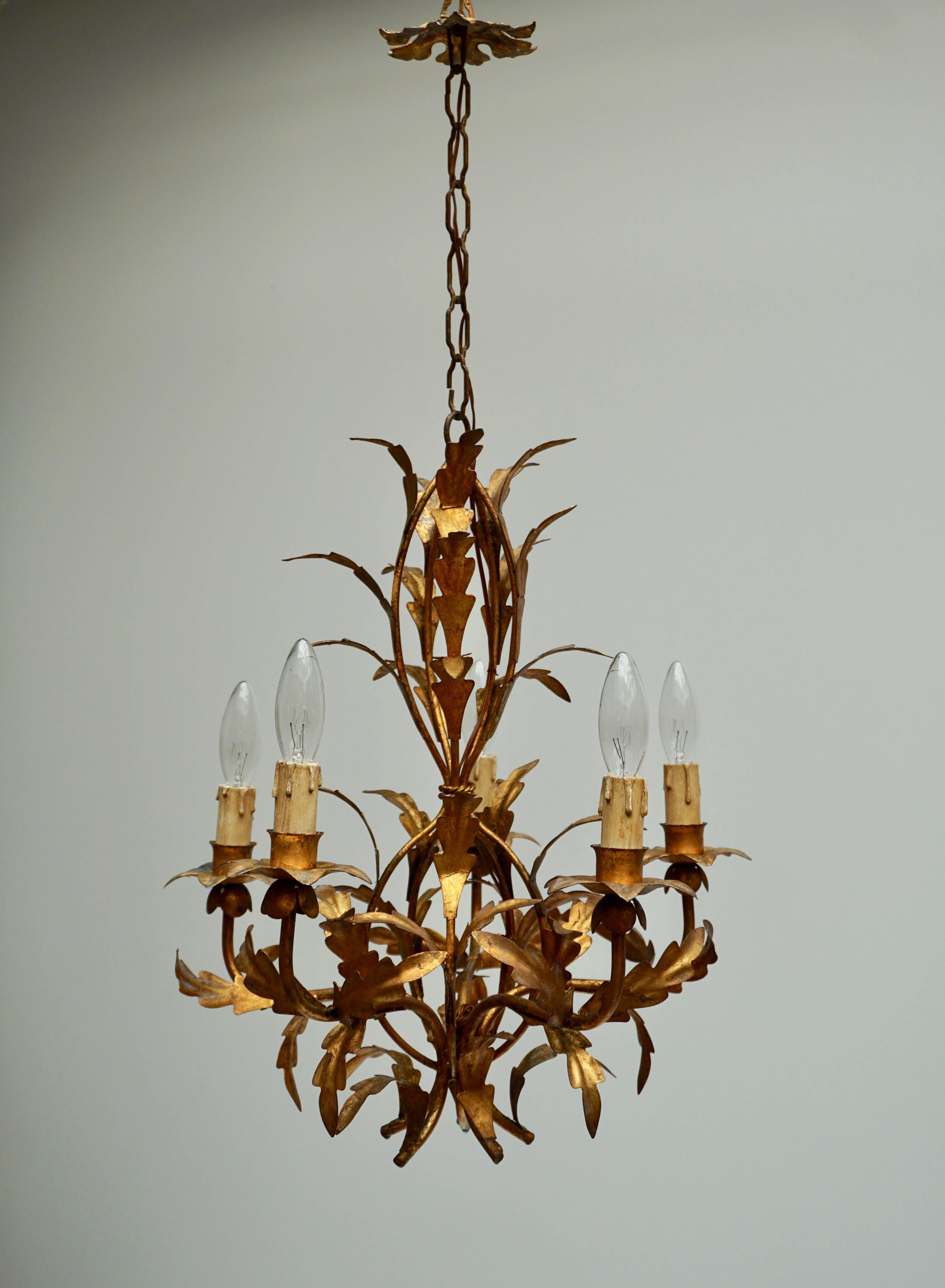 Highly decorative handcrafted gold leaf gilt iron five light chandelier. This five branches tole chandelier is hand-painted and has gold leaf finish and a lovely vintage patina. Small leaves surrounding each branch make this piece gorgeous.
Total