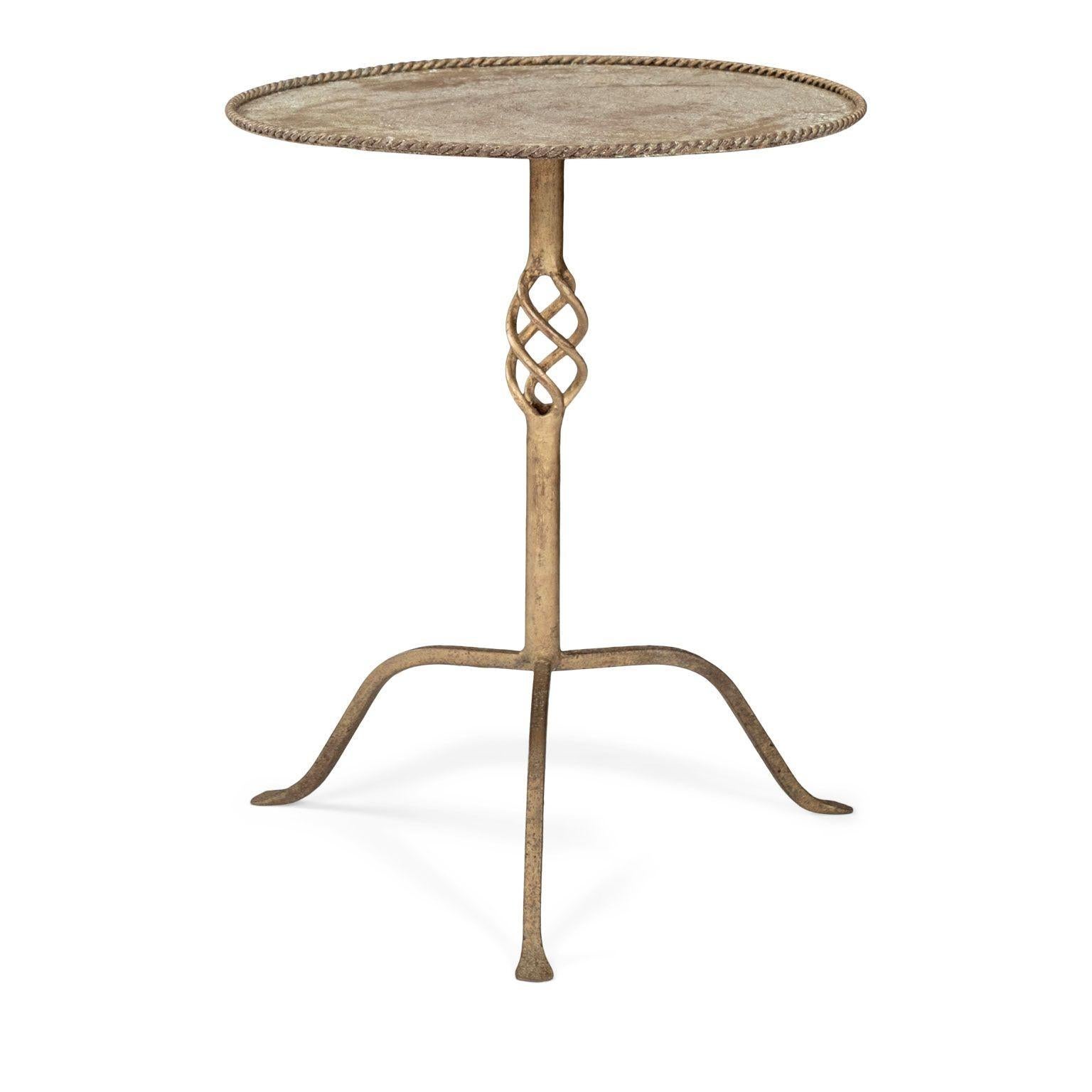 Gilt-iron martini table circa 1950-1969, Spain. Low twisted-iron gallery, spiraled decoration and tripod base. Original gilded finish accentuated by milding scaling and patina from age.

Note: Original/early finish on antique and vintage metal will