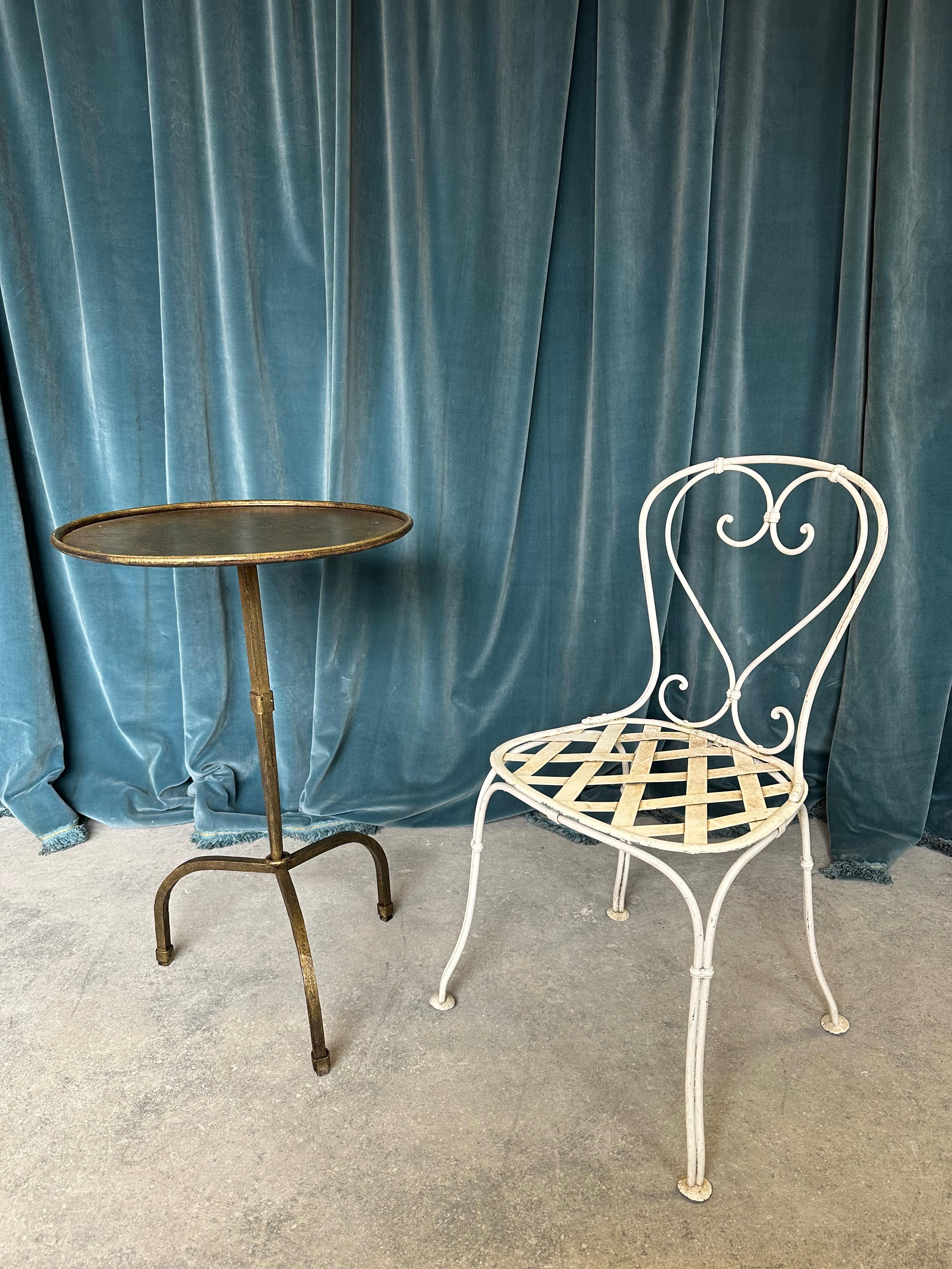 This recently crafted small Spanish iron end table is not only elegant but functional.  The small scaled side table, or better yet a drinks table, stands out with a circular central stem, highlighted by an intriguing collar accent that serves as a