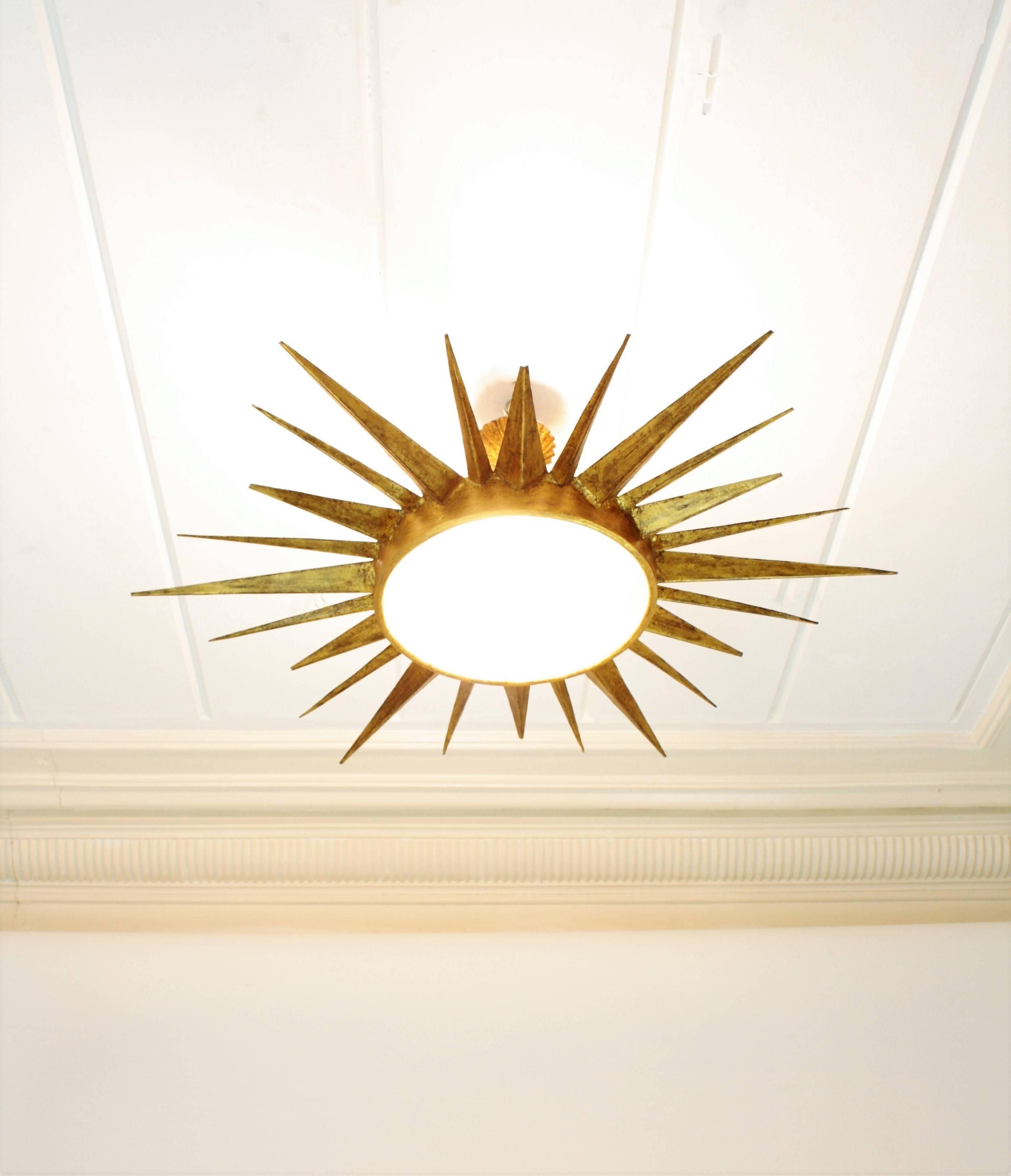 Spanish Mid-Century Modern Gilt Iron Sunburst Ceiling Light Fixture and Sunburst Mirror